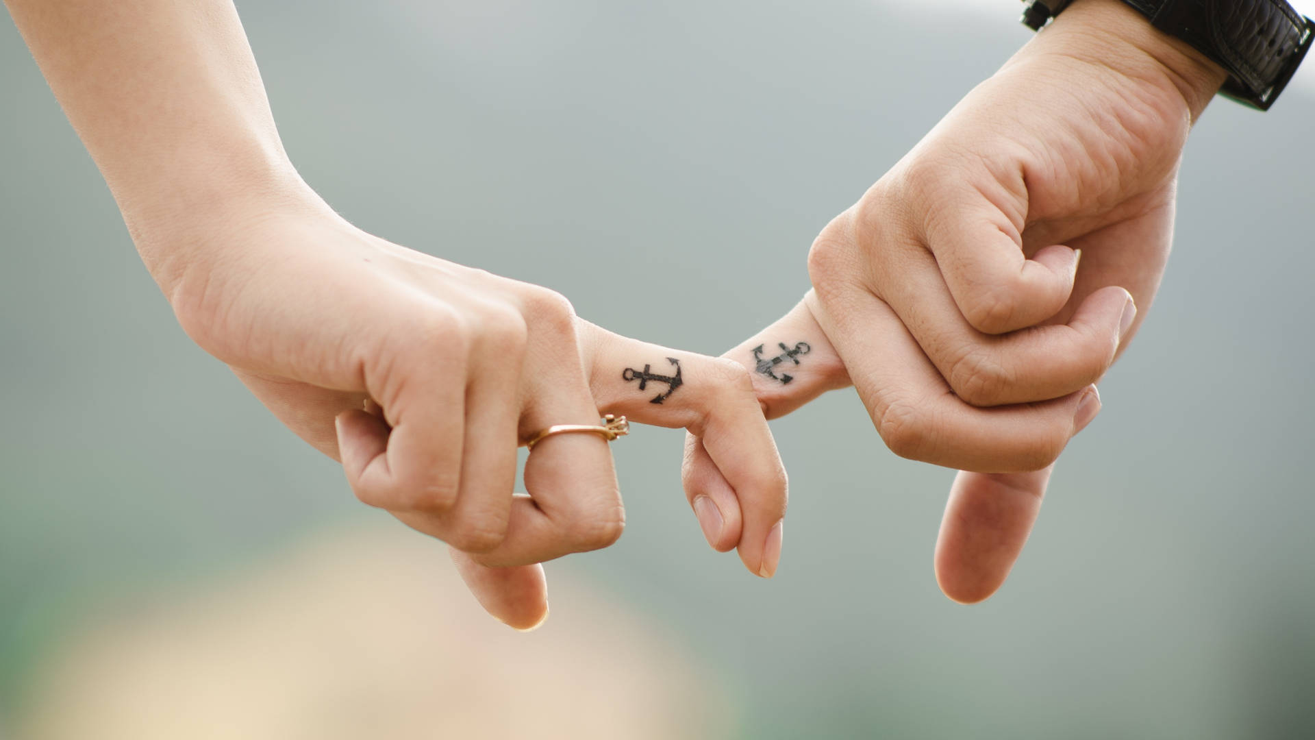 Sweet Holding Hands With Anchor Tattoos Wallpaper