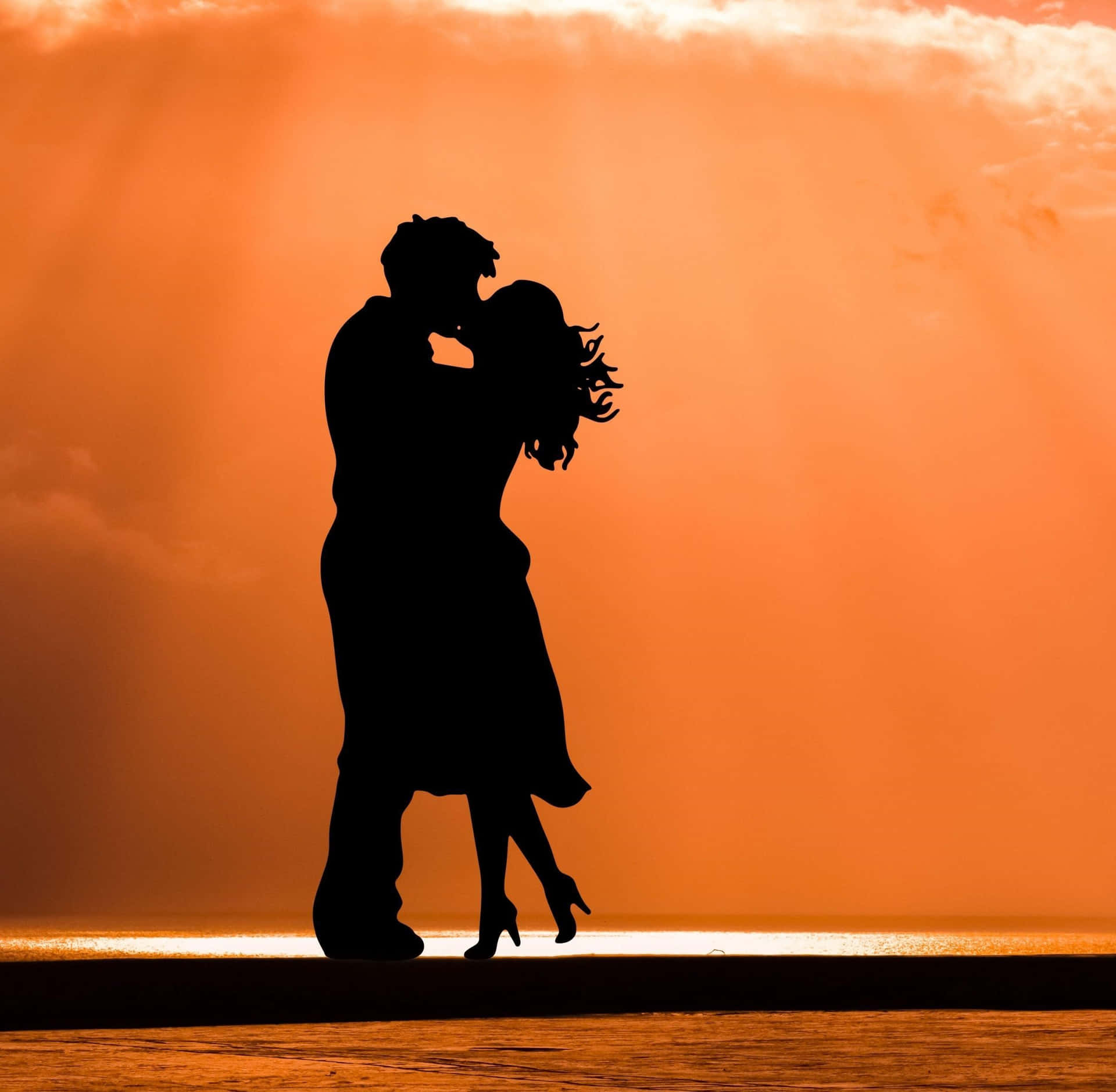 A Couple Kissing In The Sunset