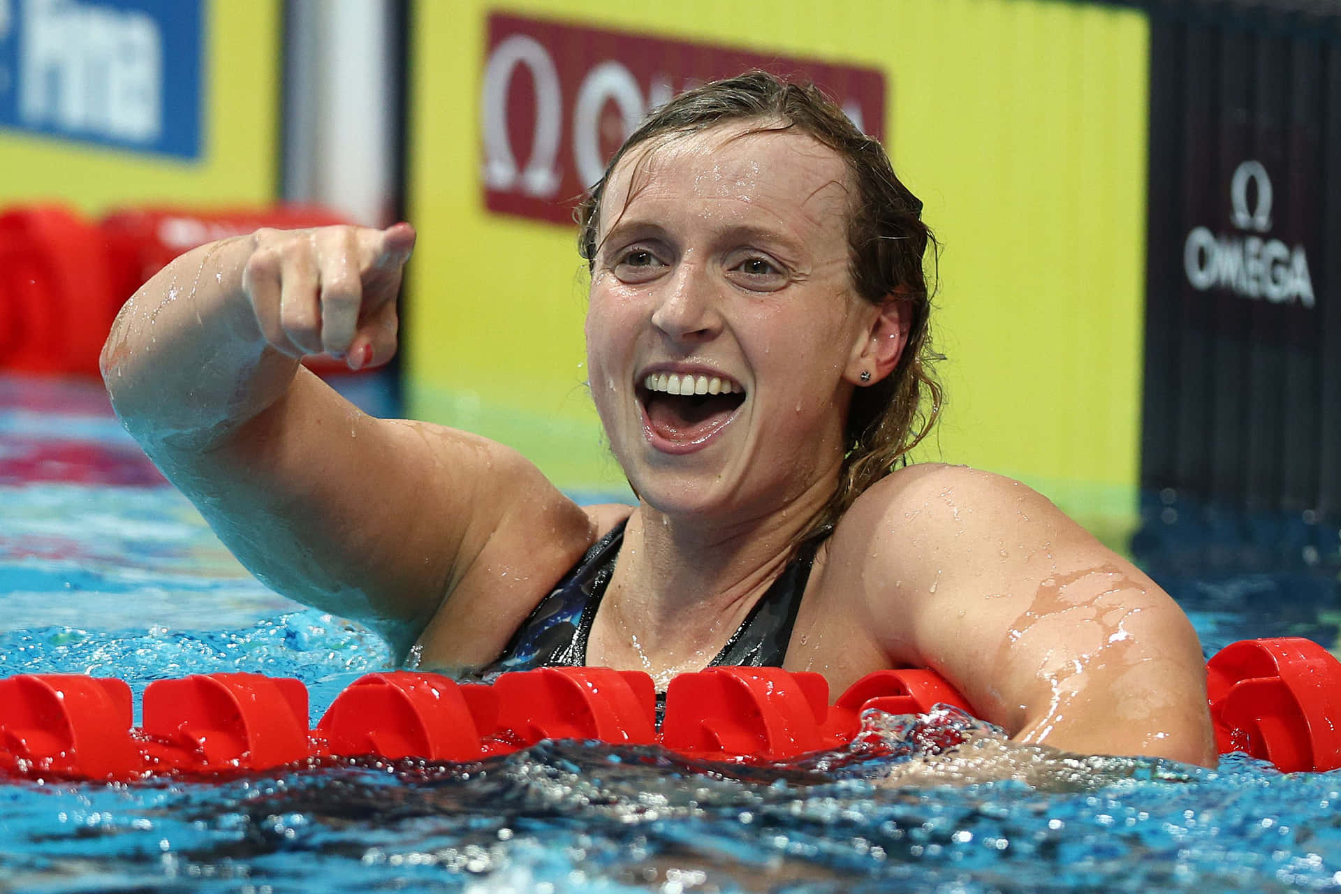 Swimmer Celebrating Victory Poolside Wallpaper