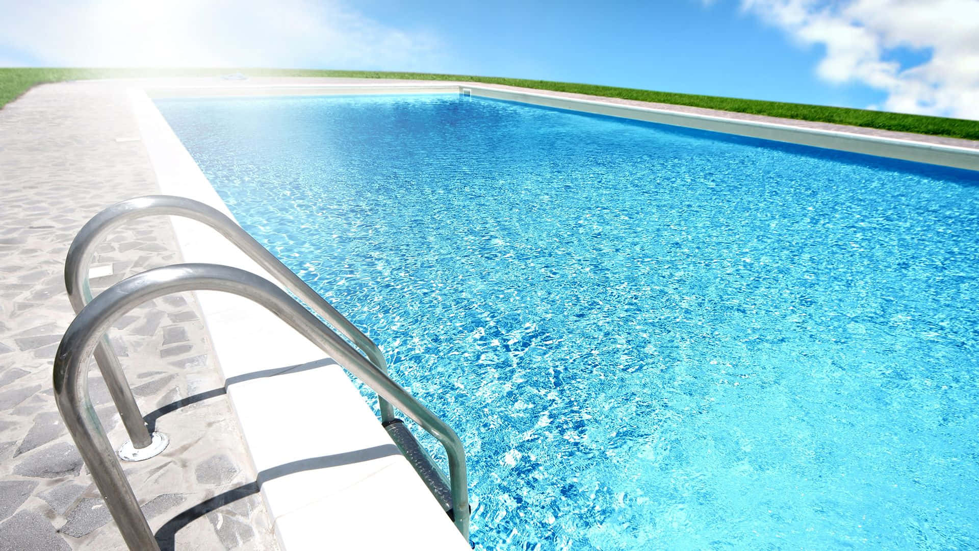 A beautiful backyard swimming pool on a sunny day