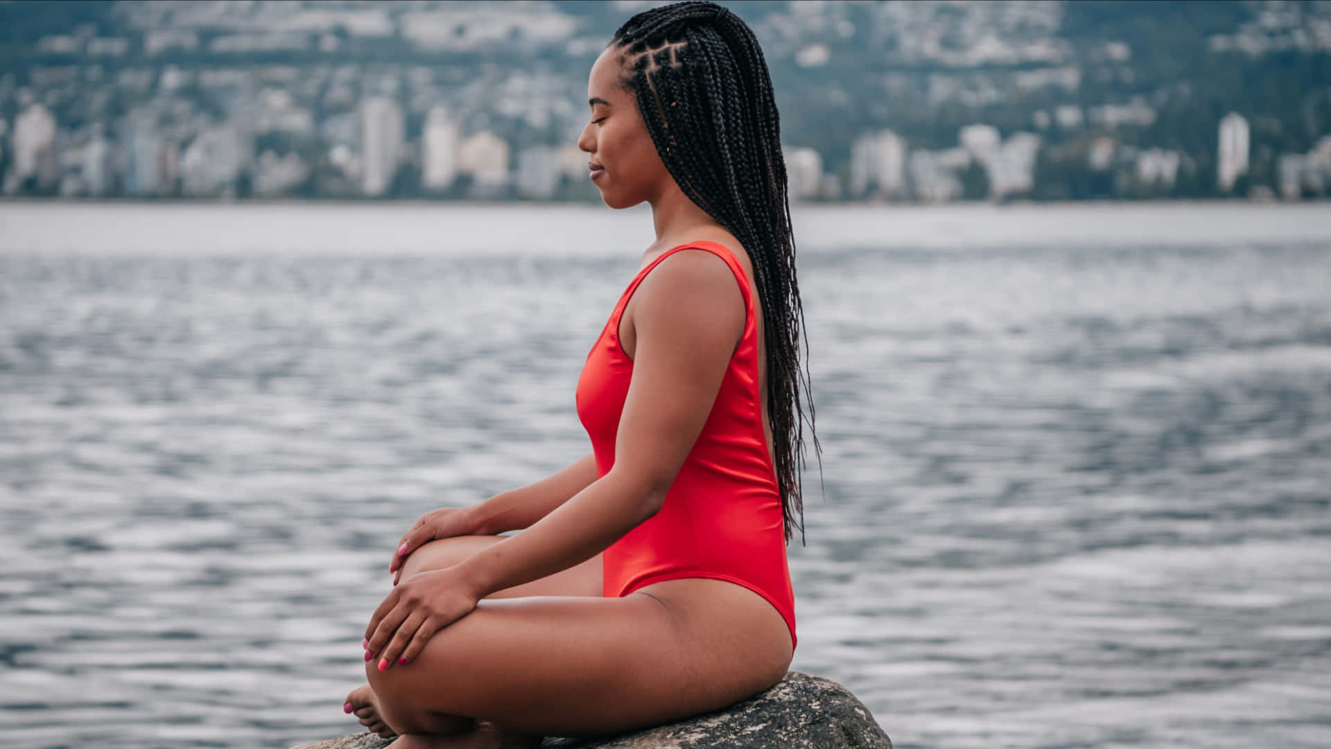 Elegant Swimsuit Model Meditating on the Beach Wallpaper