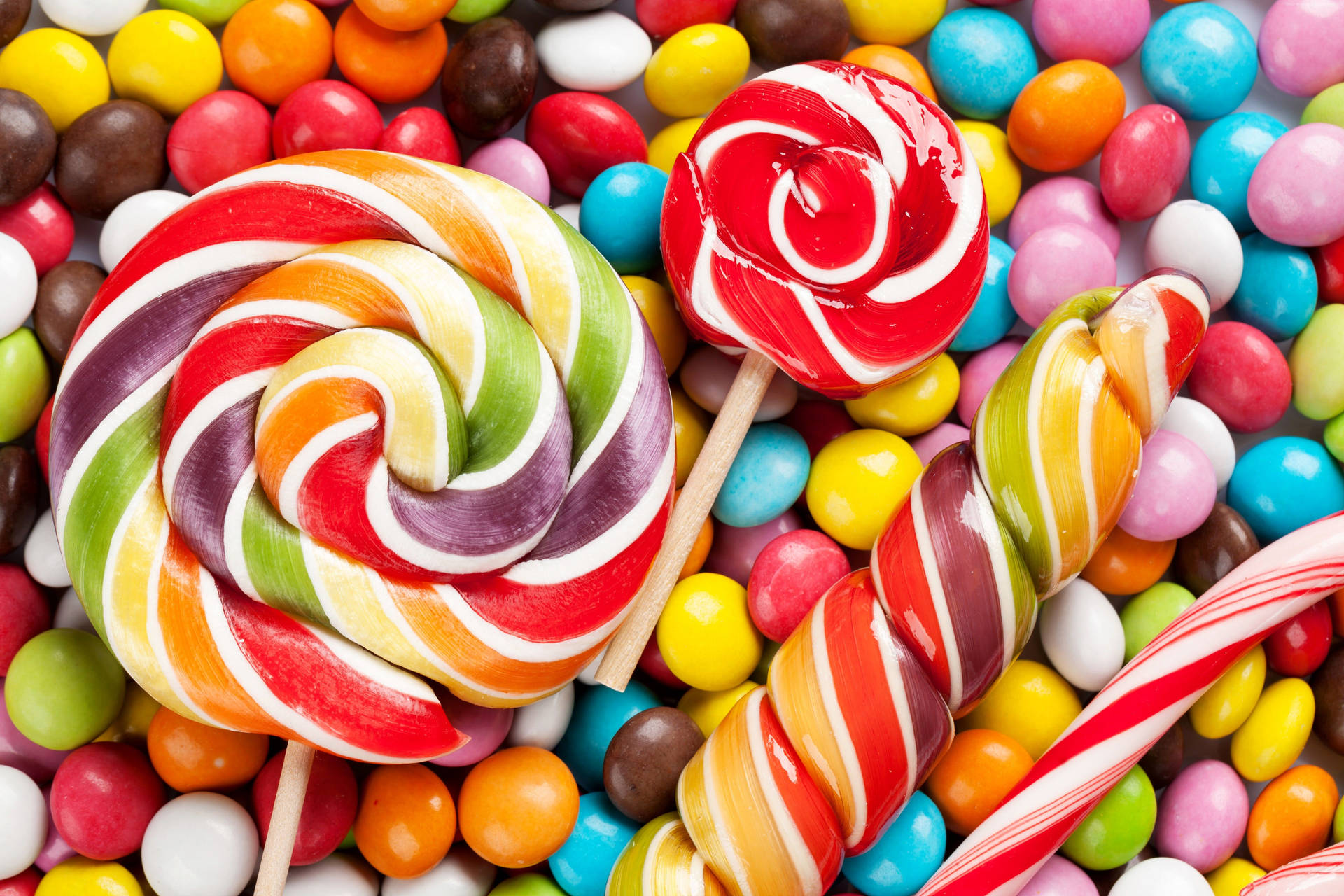 Swirly Lollipop And Round Candies Wallpaper