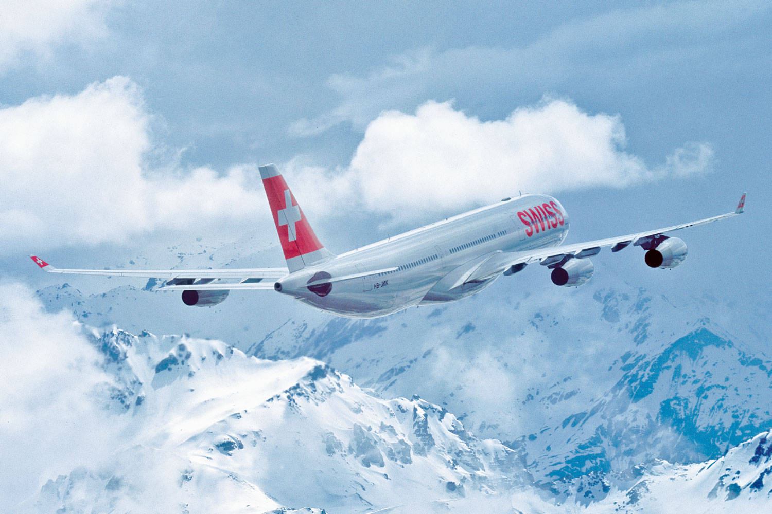 Swiss Airlines Airplane On A Cloudy Mountain Background