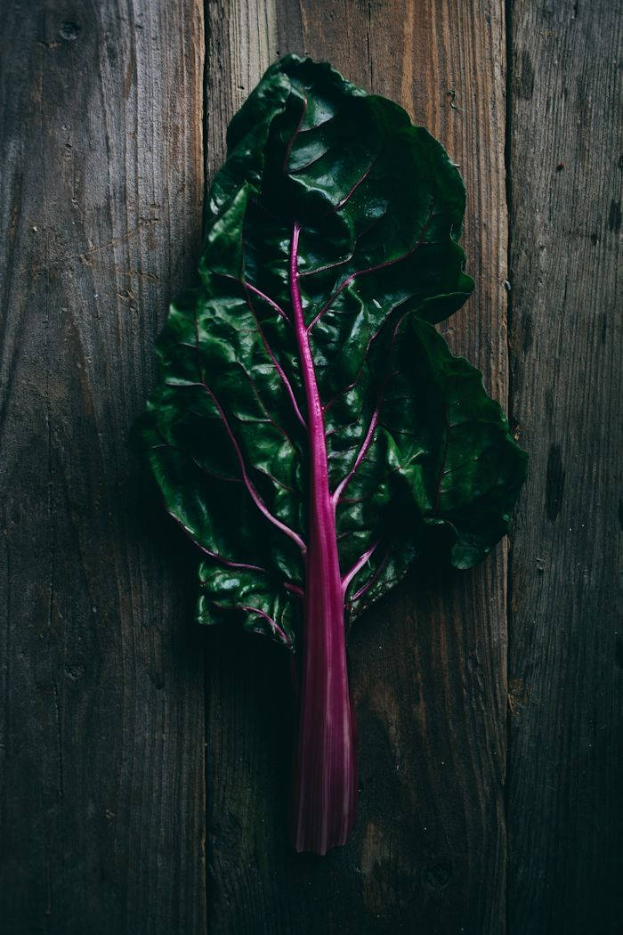 Fresh Swiss Chard on Rustic Wooden Table Wallpaper