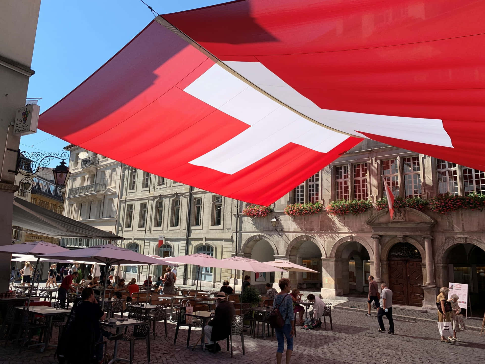 Download Swiss_ Flag_ Over_ Lausanne_ Street_ Scene Wallpaper ...