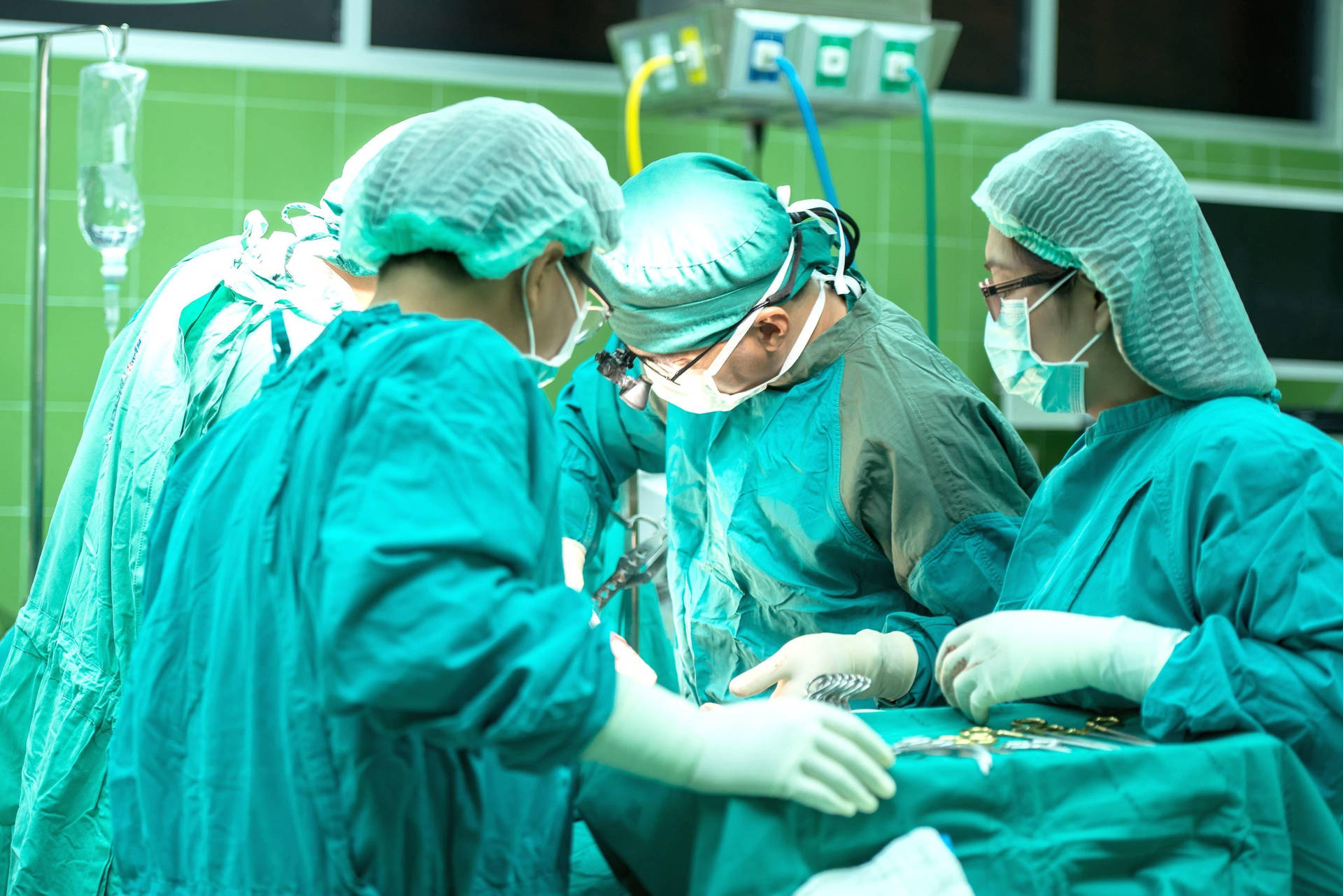 Focused Swiss Surgeon Performing Surgery Wallpaper