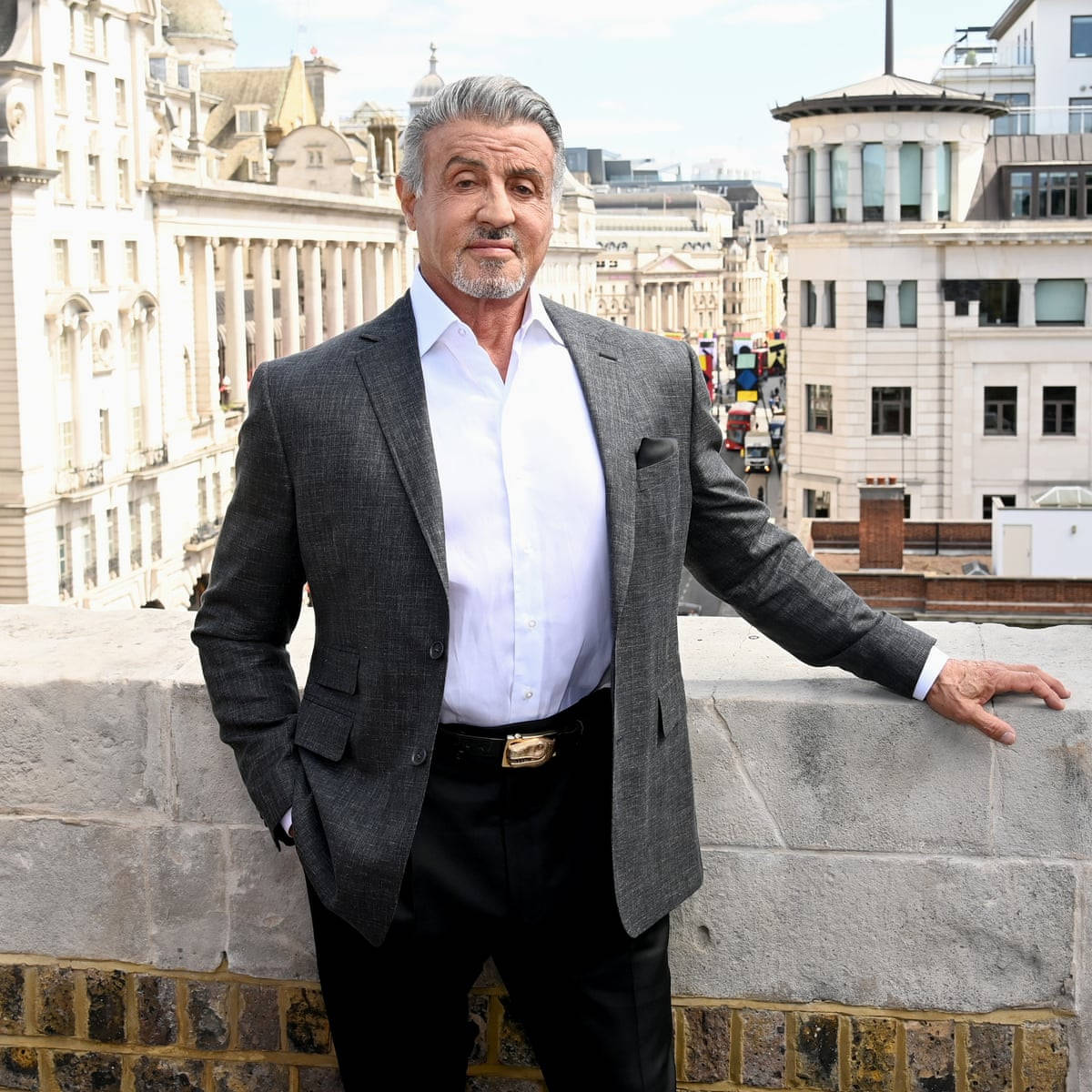 Sylvester Stallone Leaning On Concrete Wall Wallpaper
