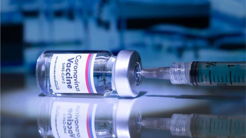 Syringe Inserted In A Vial Coronavirus Vaccine Background