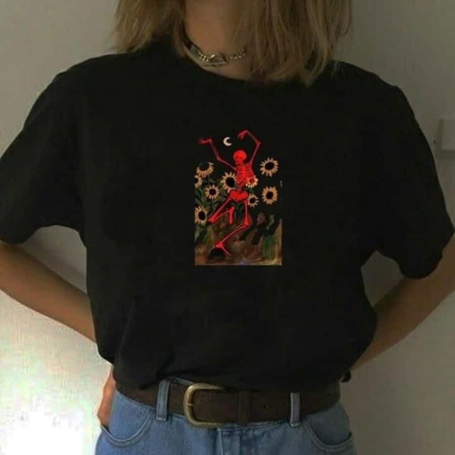 A Woman Wearing A Black T - Shirt With A Red Flower On It