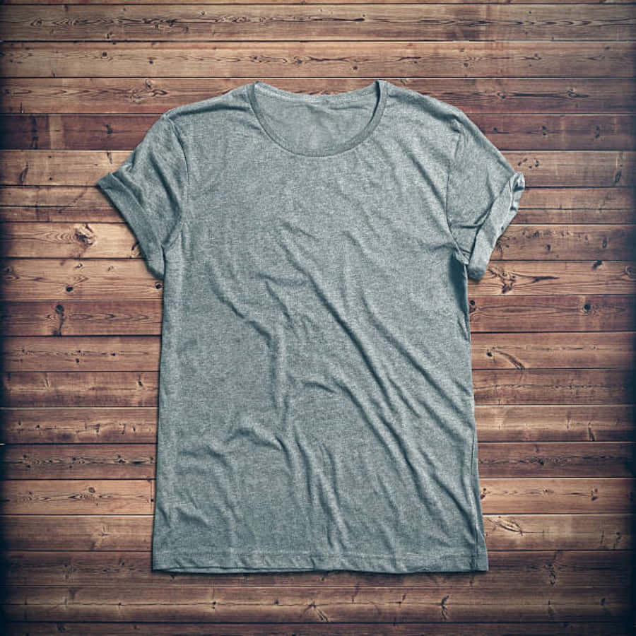 A Grey T - Shirt On A Wooden Background