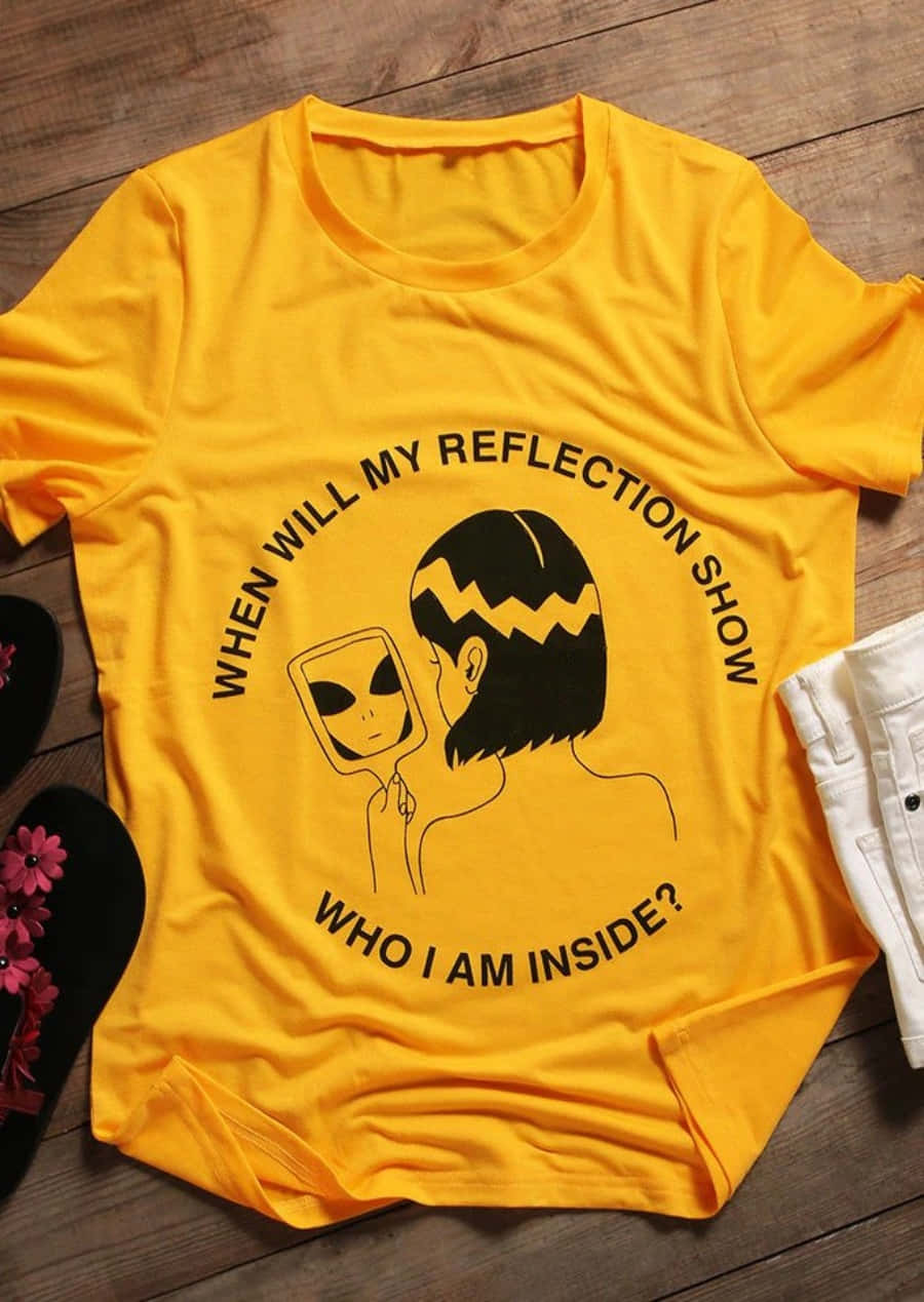 A Yellow Shirt That Says When Will My Reflection Show Who Am I Inside?