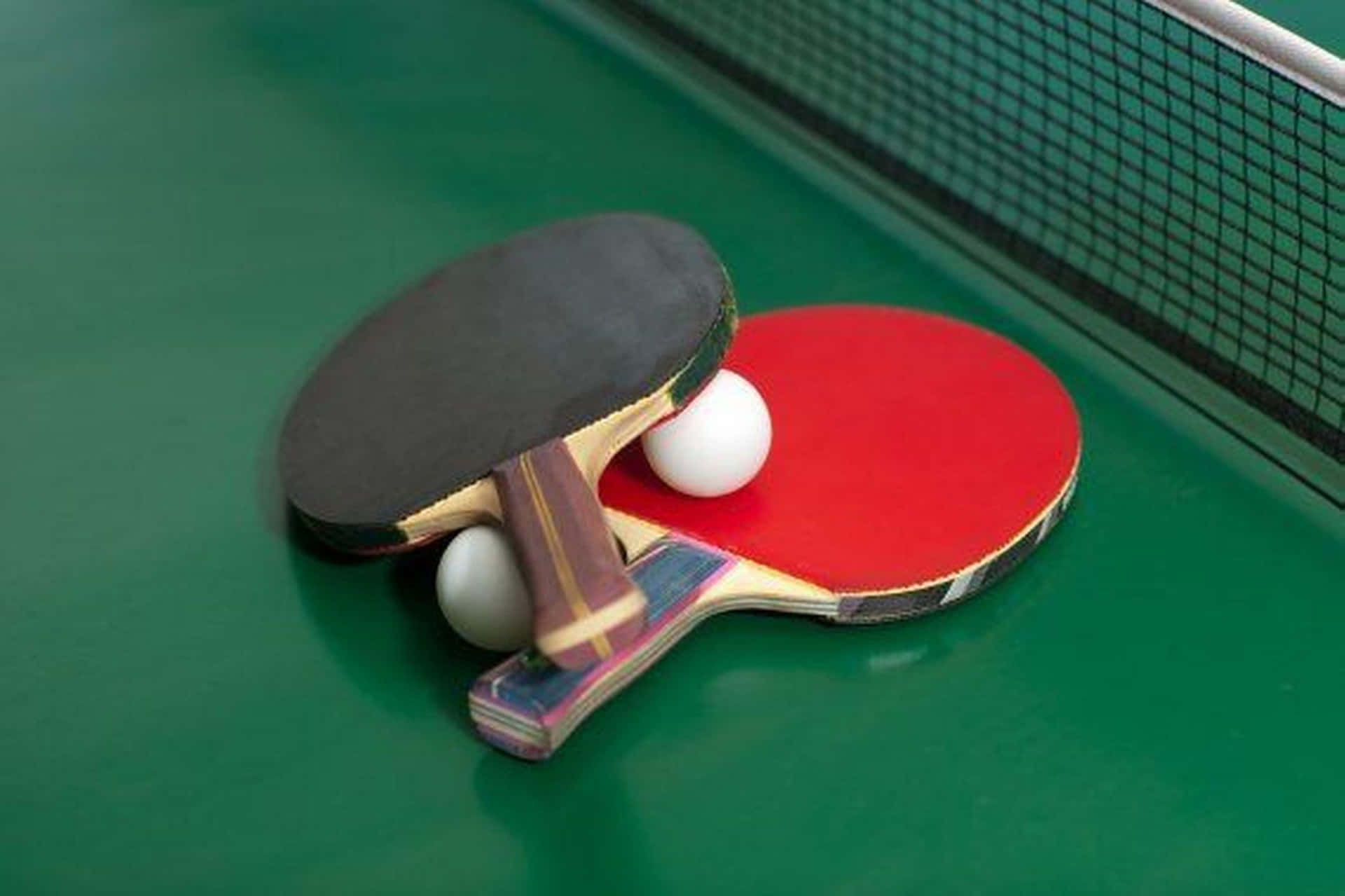 Ping Pong Paddles On A Green Table