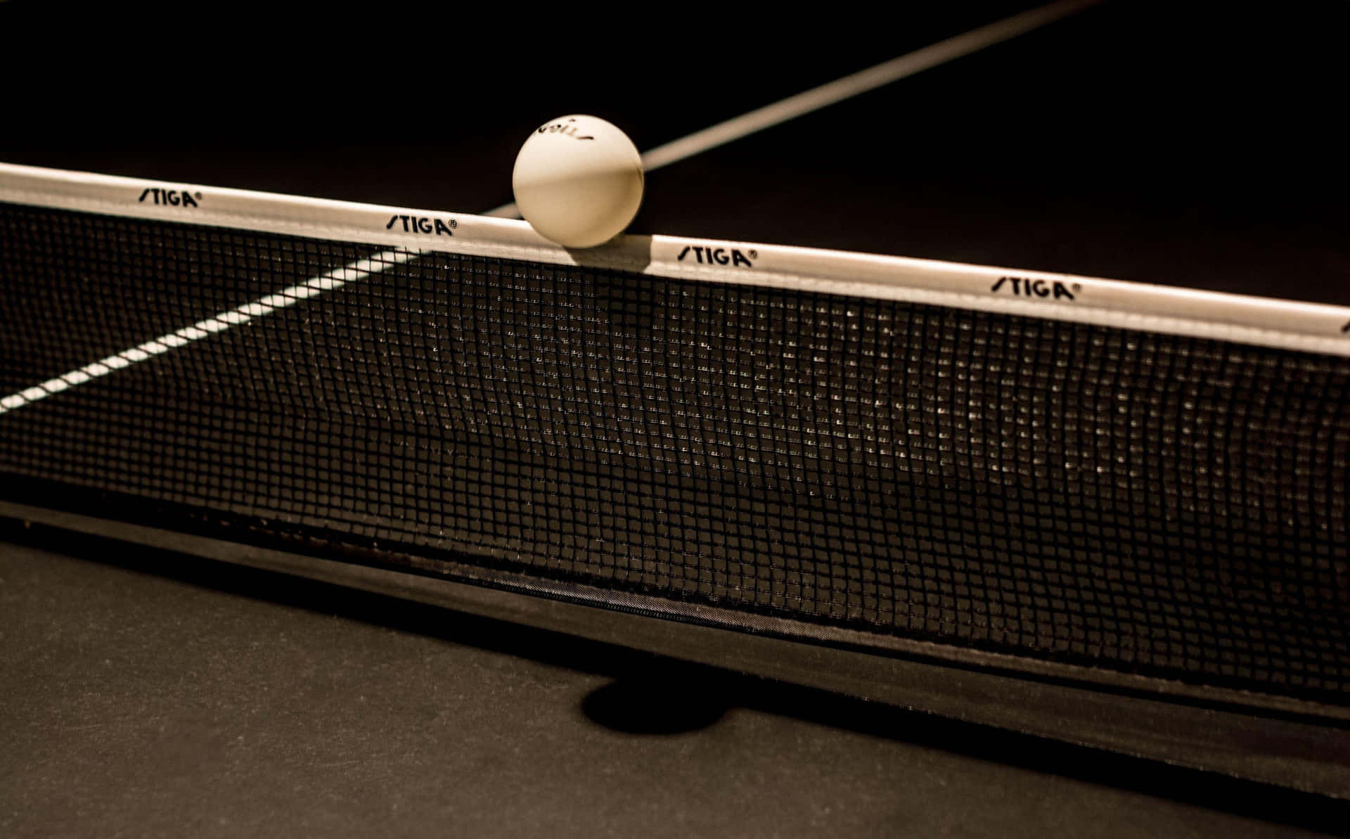 A Ping Pong Ball Is Sitting On A Net