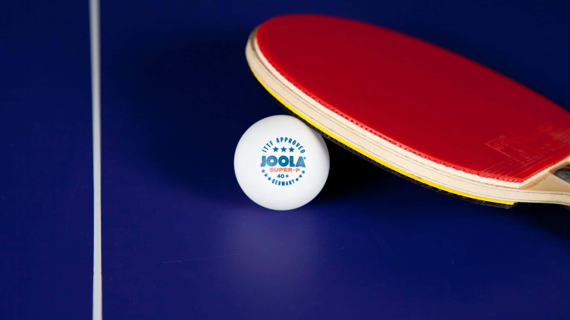 A Ping Pong Paddle And An Egg On A Table