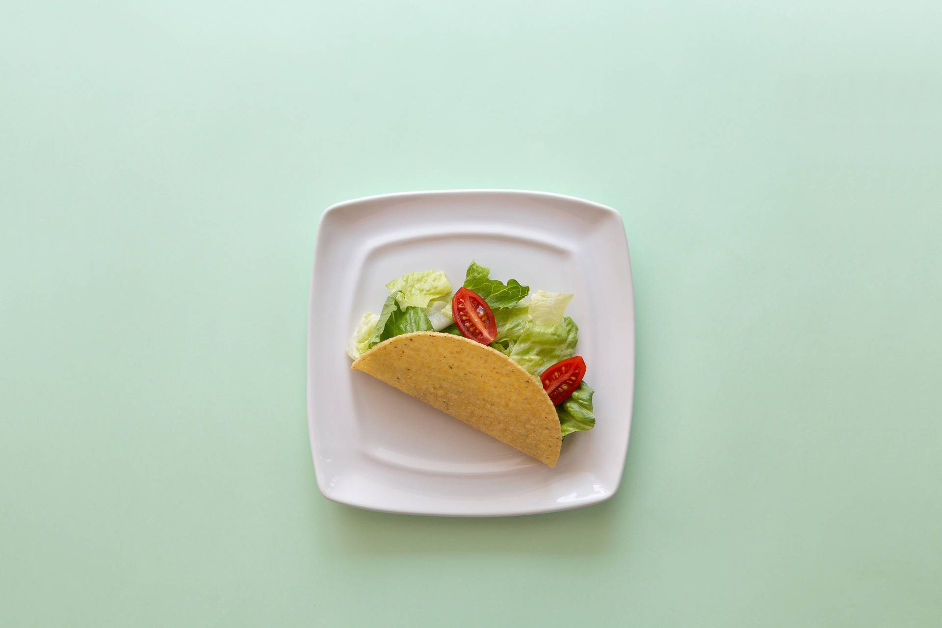 Taco On Pastel Green Table Wallpaper