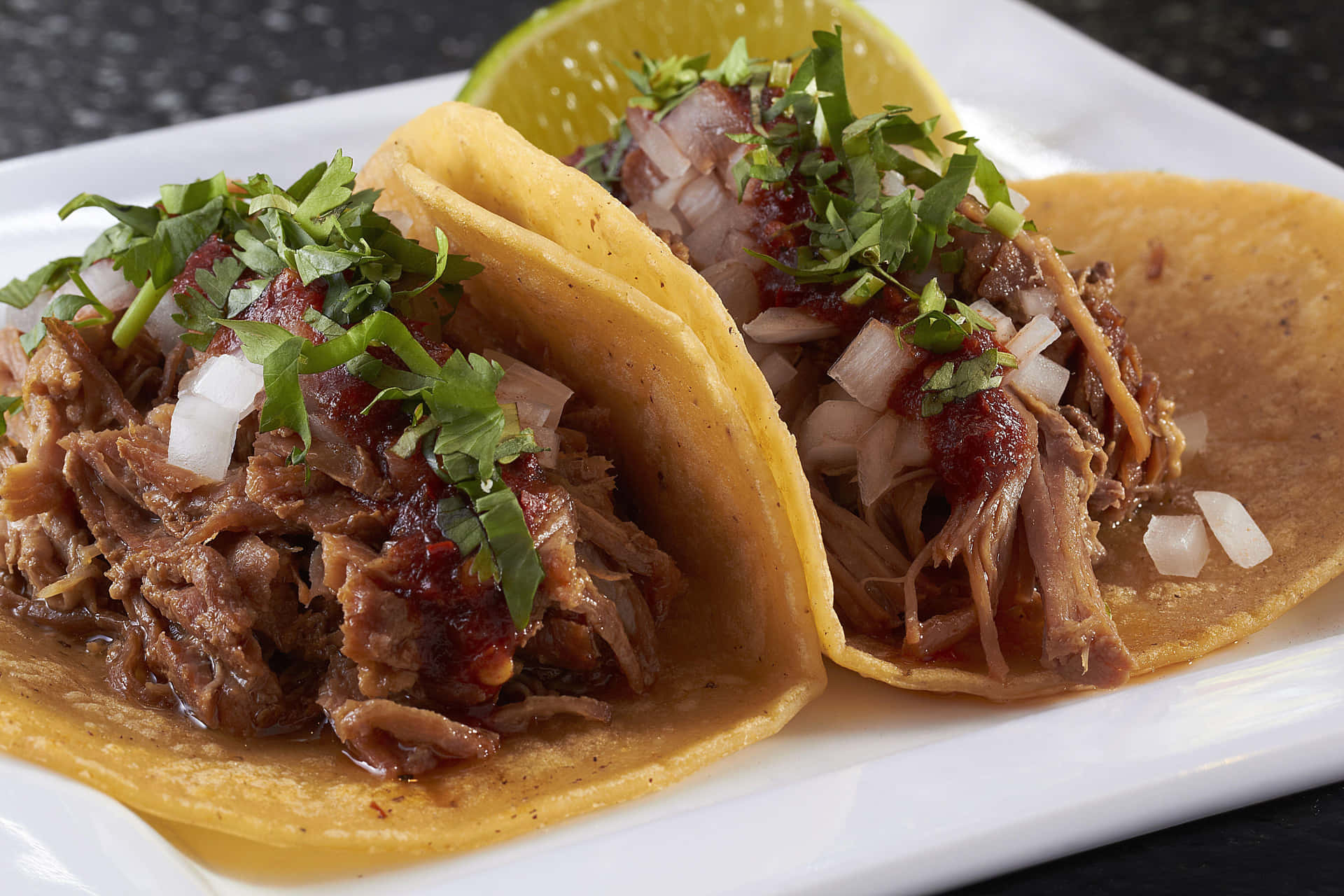 Two Pulled Pork Tacos On A Plate