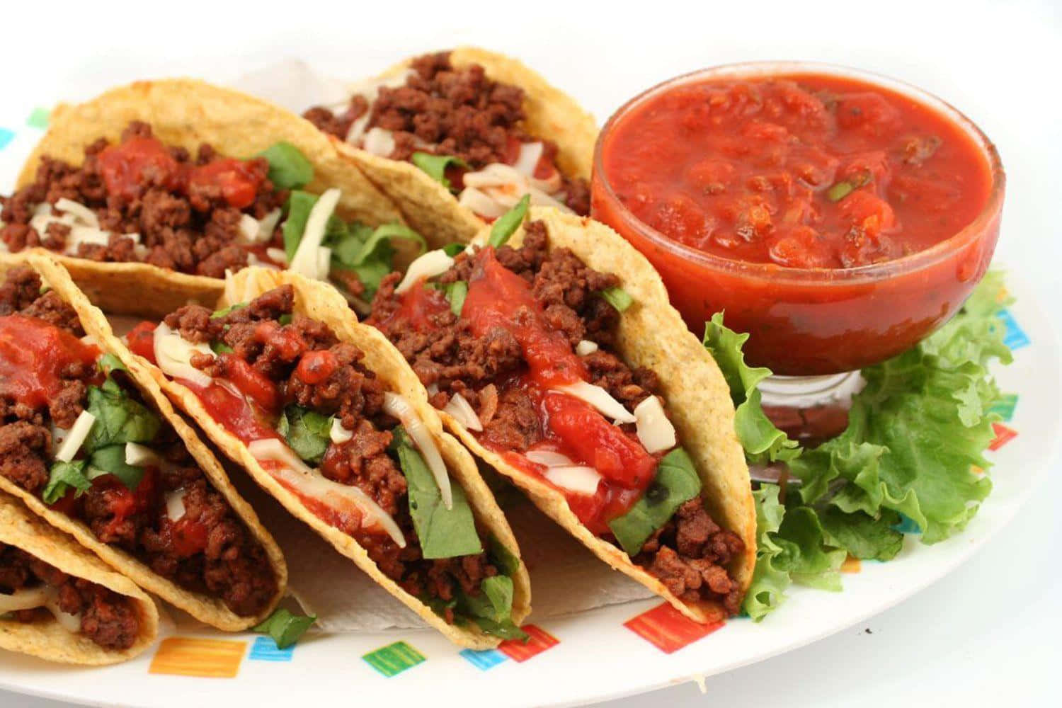 A Plate Of Tacos With Sauce And Salsa