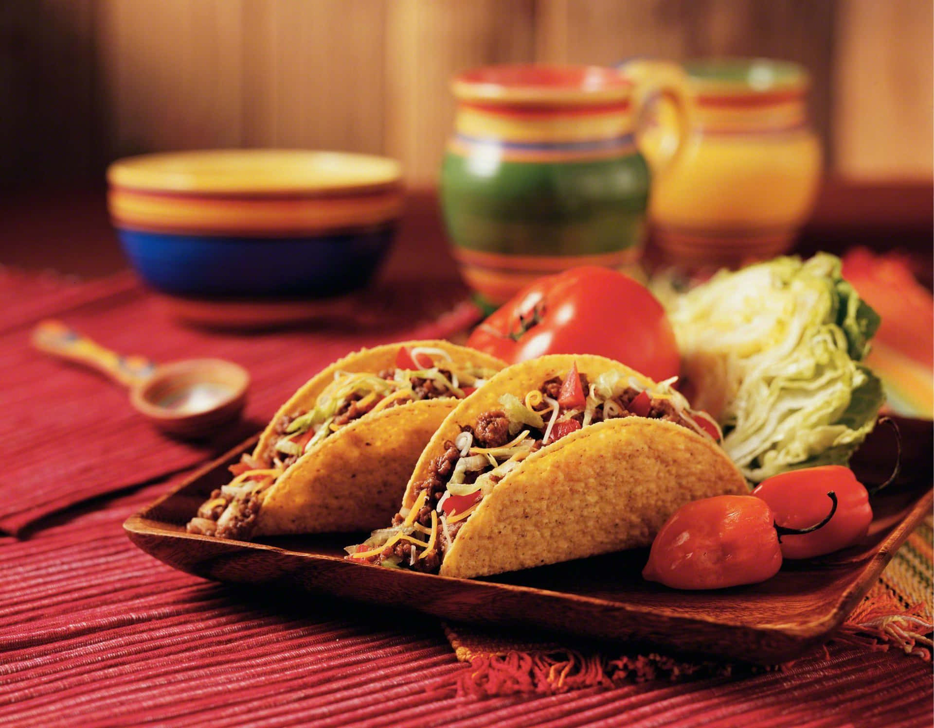 A Plate Of Tacos With Vegetables And Sauce