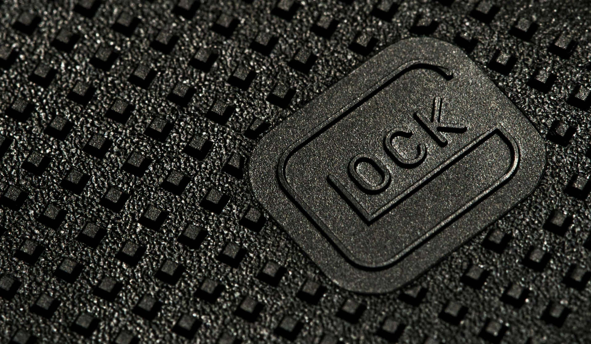 A Close Up Of A Black Leather Bag With A Logo On It Wallpaper