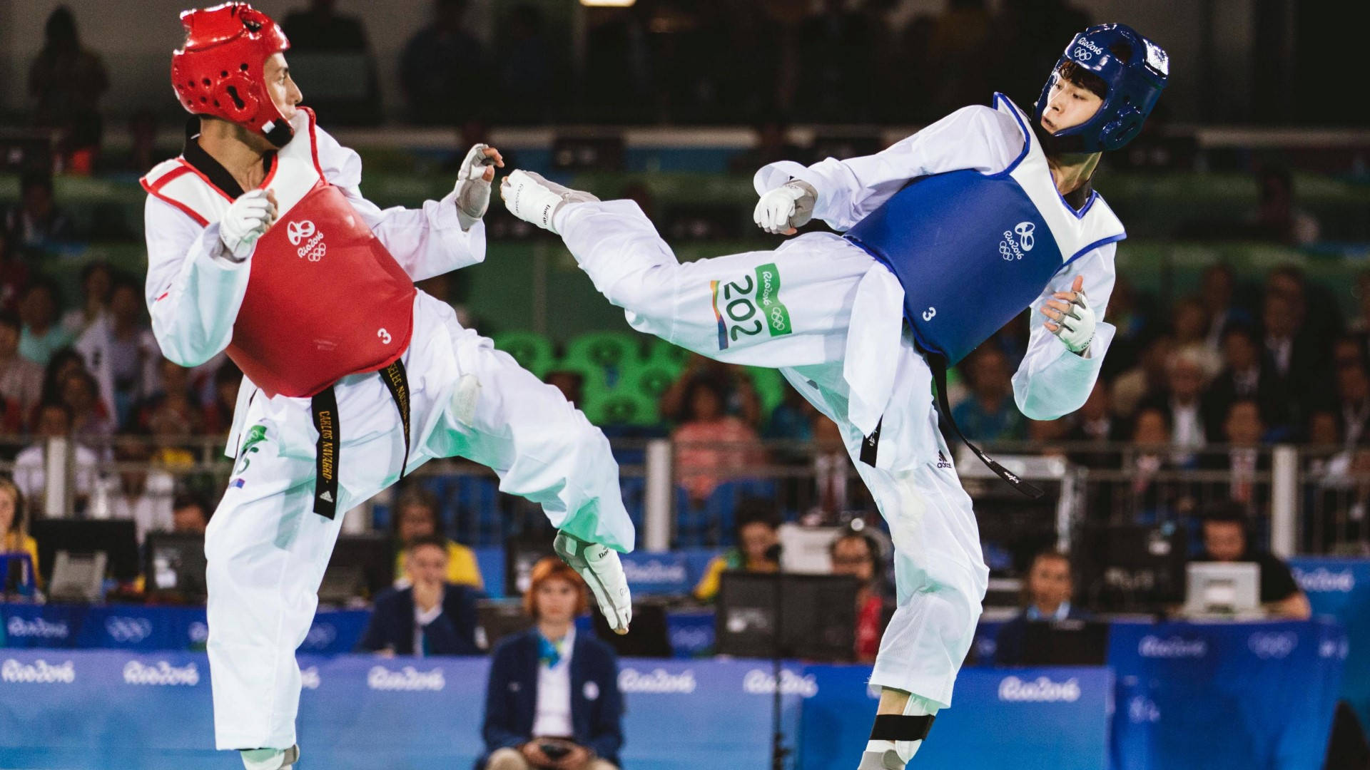 Caption: Professional Taekwondoka in Action at the Rio Summer Olympics 2016. Wallpaper