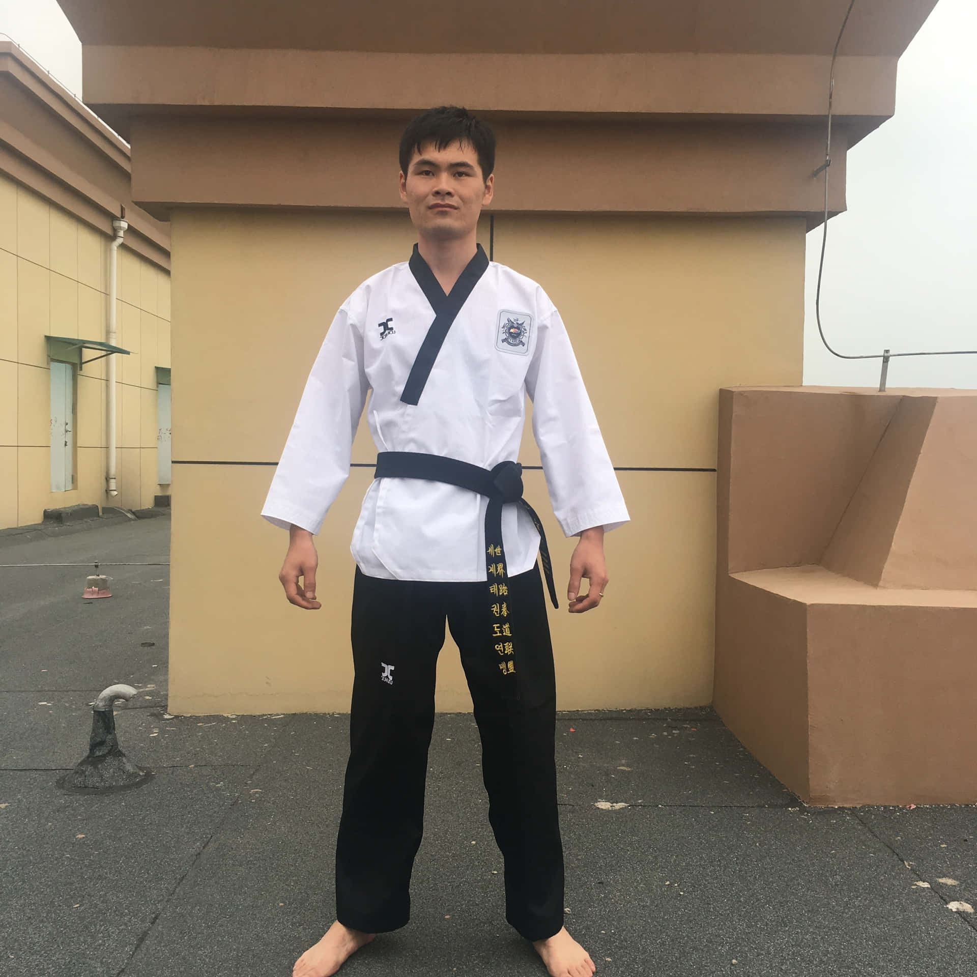 A Competitor Prepares for Taekwondo Competition in a Uniform Wallpaper