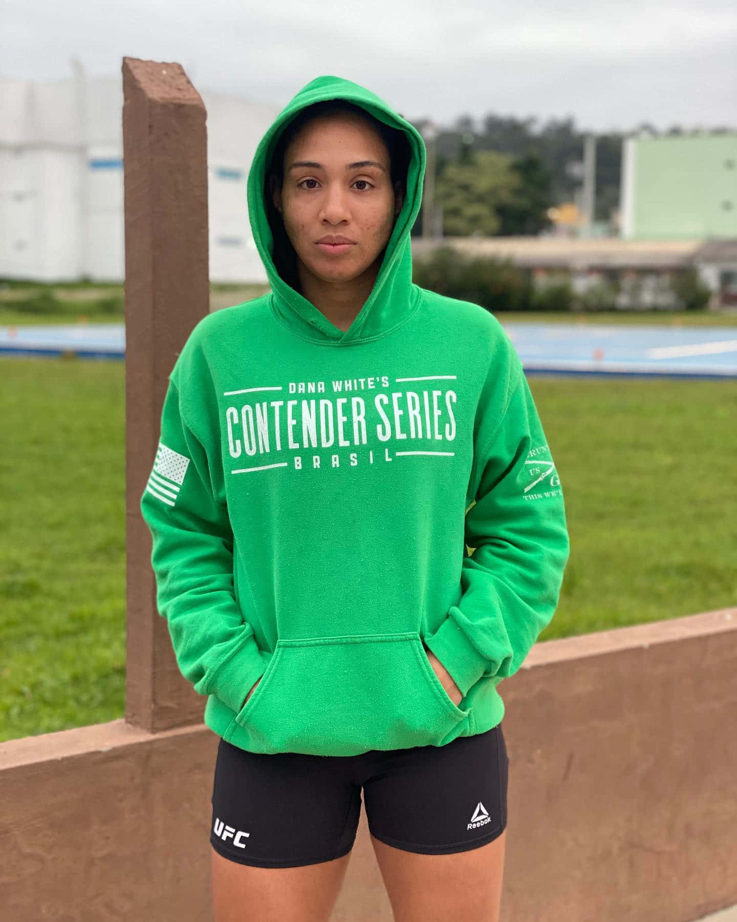 Taila Santos Wearing A Green Hoodie Background