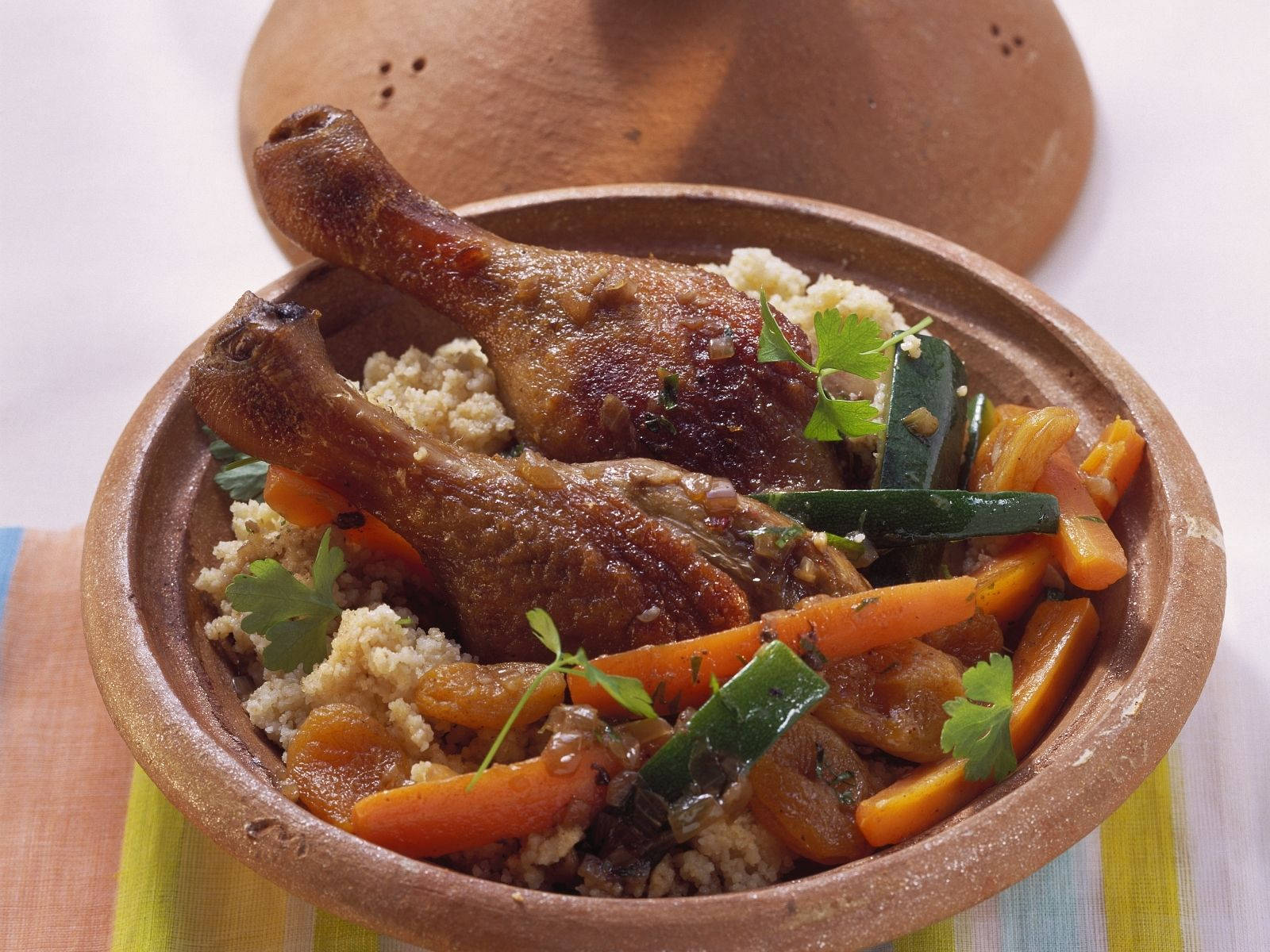A Delicious Chicken Drumstick Tajine Dish On Table Wallpaper
