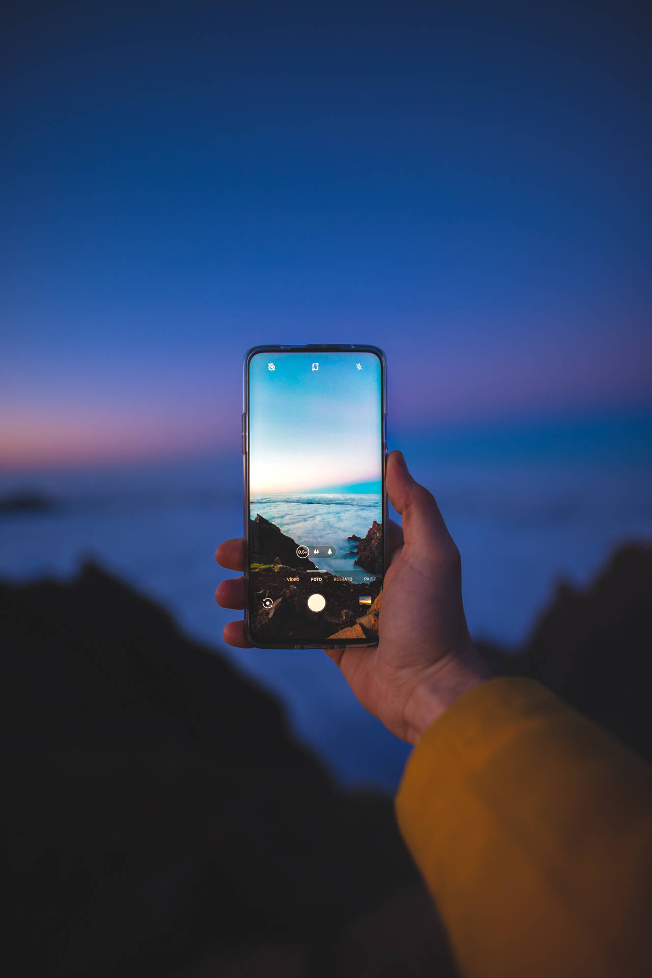 Taking Seaside Photo Using Phone Wallpaper