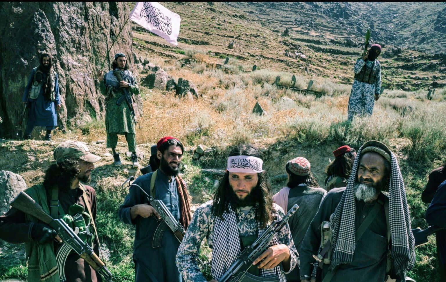 Taliban fighters posing with weapons