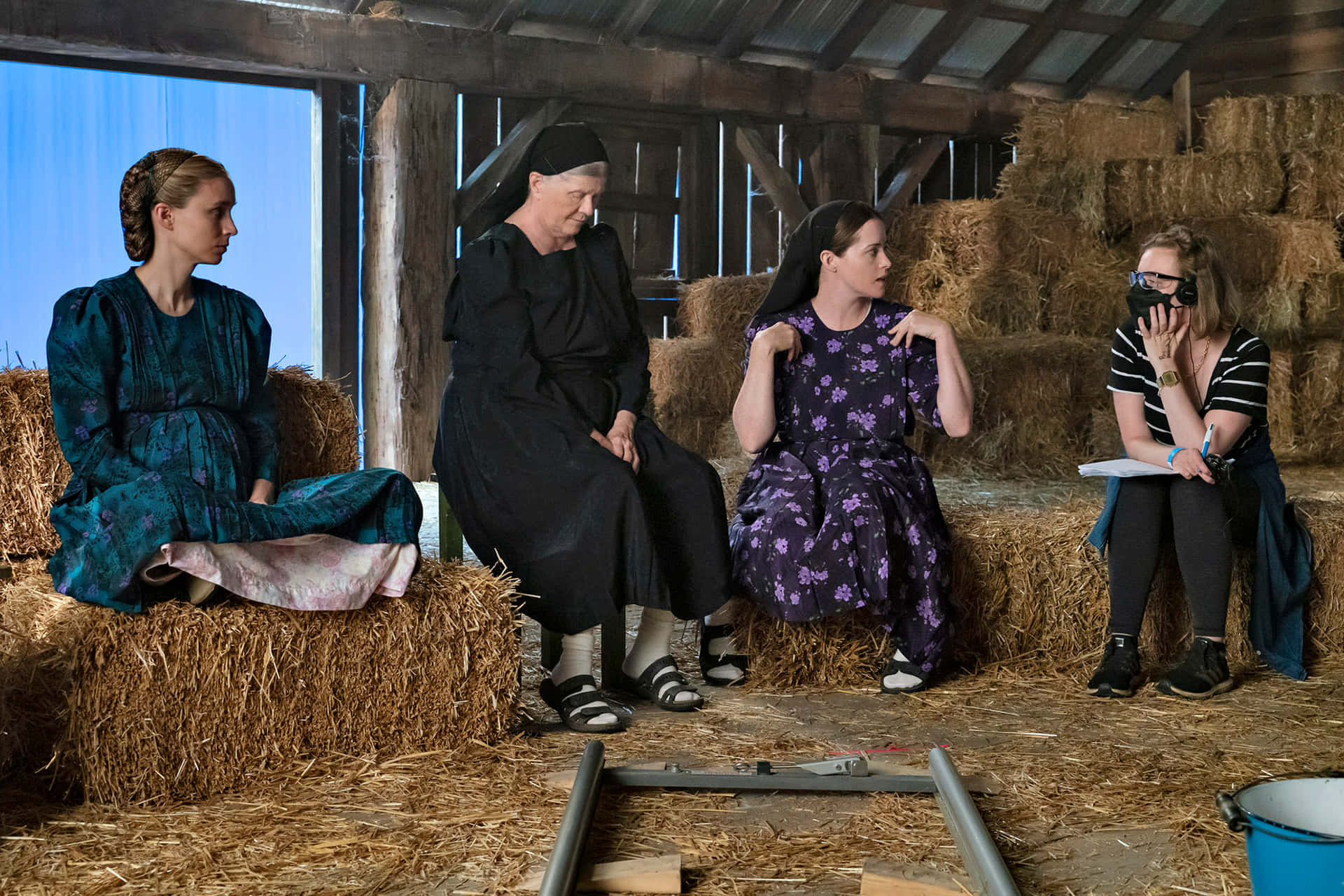 Four Women Sitting On Hay In A Barn