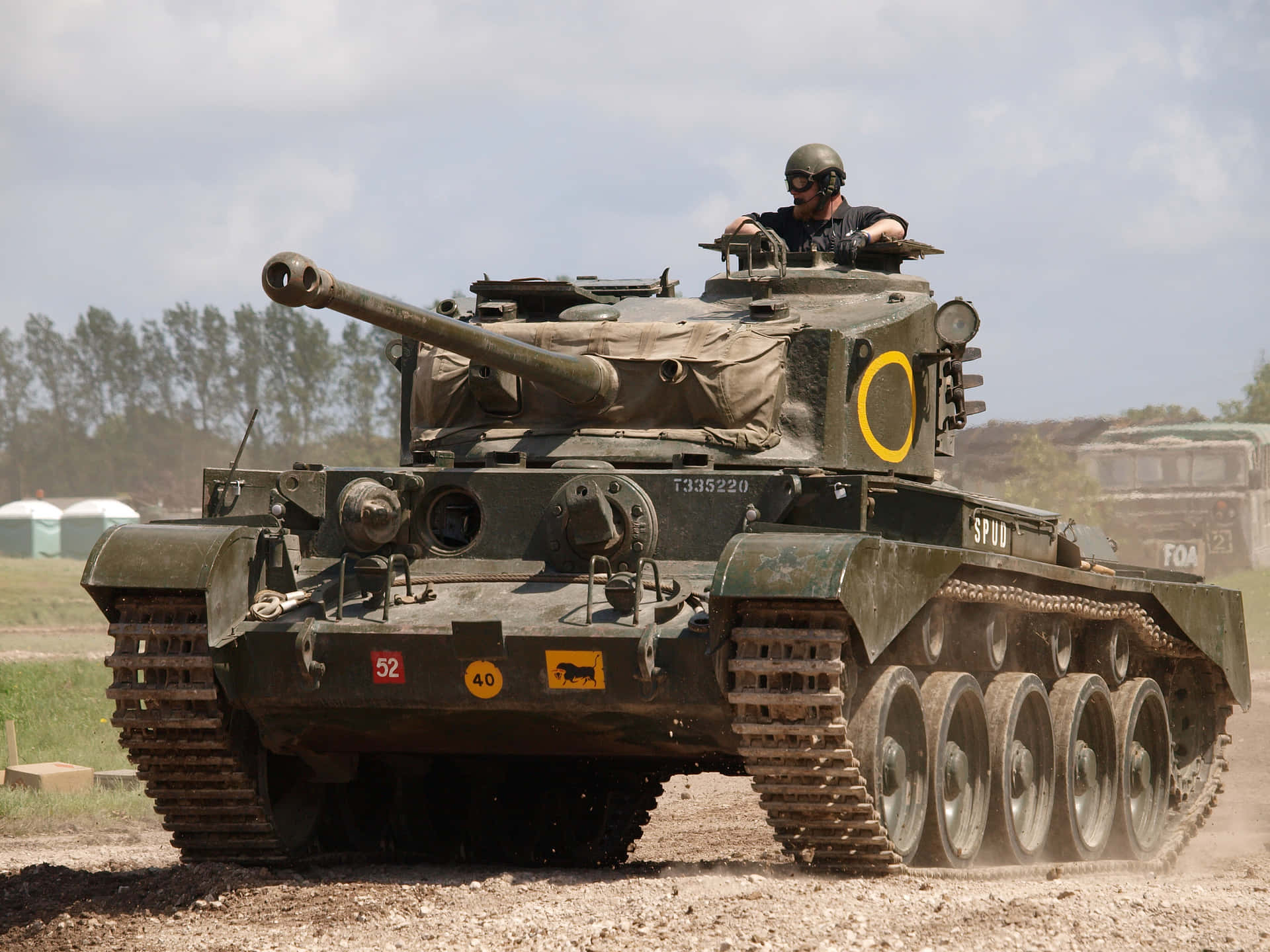 A tank on the battlefield with a man inside, ready to
