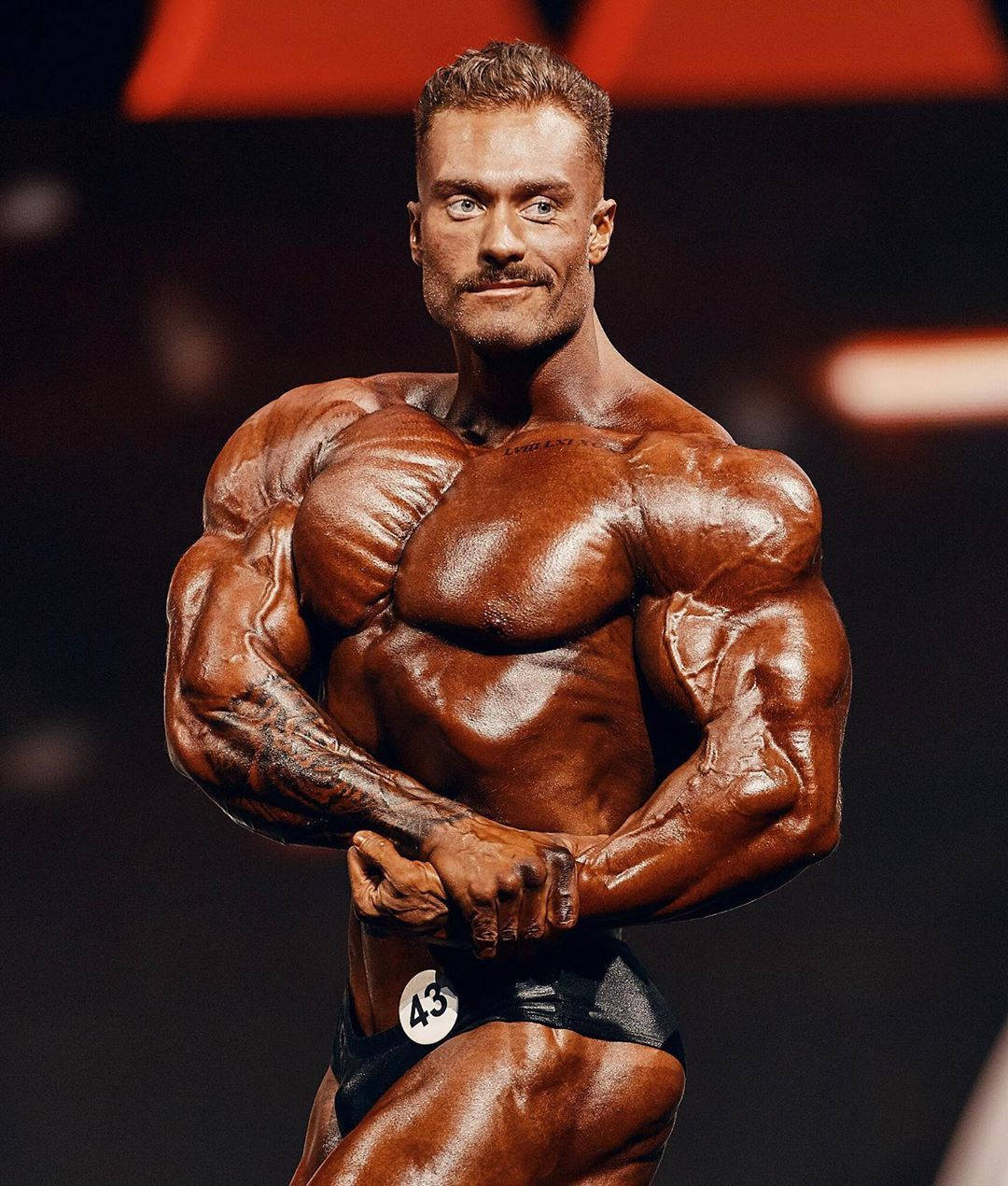 Tanned Chris Bumstead Side Chest Pose Wallpaper