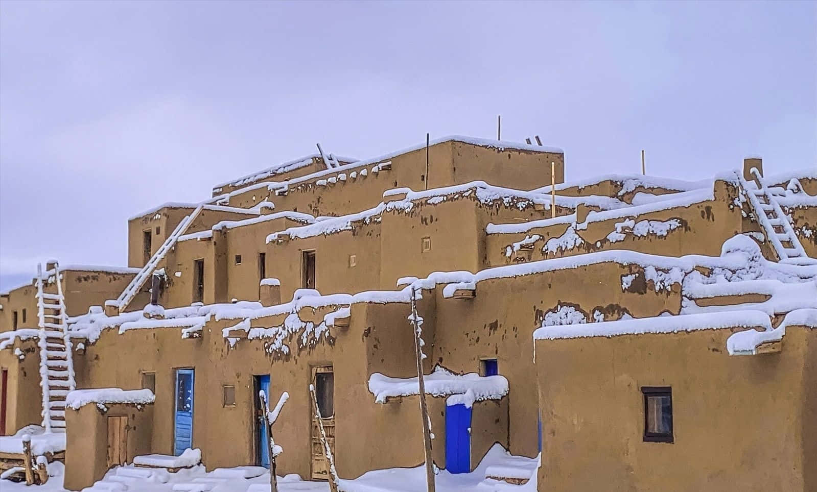 Taos Pueblo Covered In Snow Wallpaper