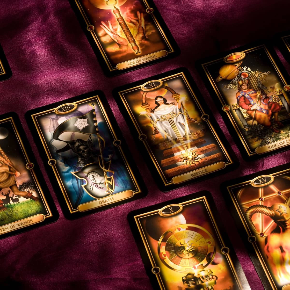 A Group Of Tarot Cards On A Purple Cloth Wallpaper