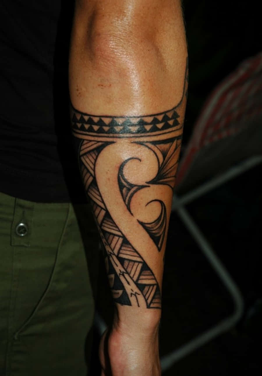 Man With Tribal Design Tattoo Arm Picture