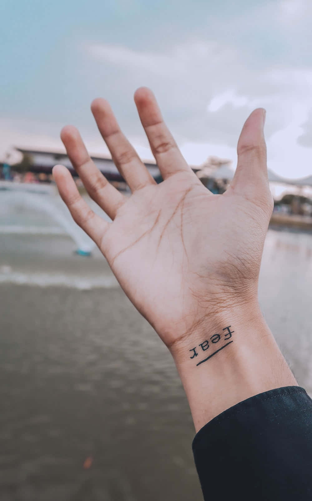 Download A Person's Hand With A Tattoo On It | Wallpapers.com