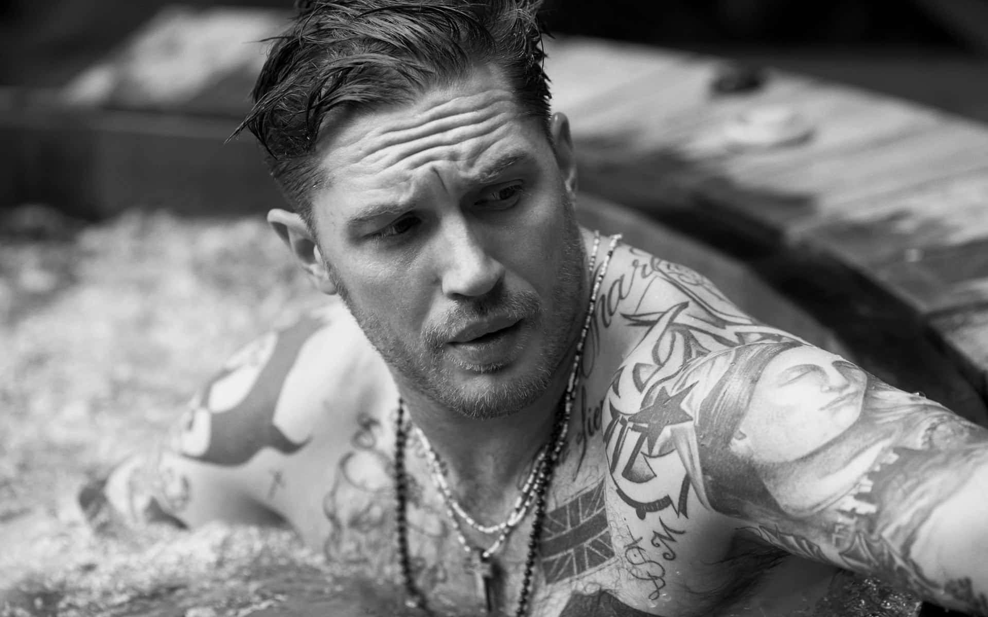 A Man With Tattoos In A Hot Tub