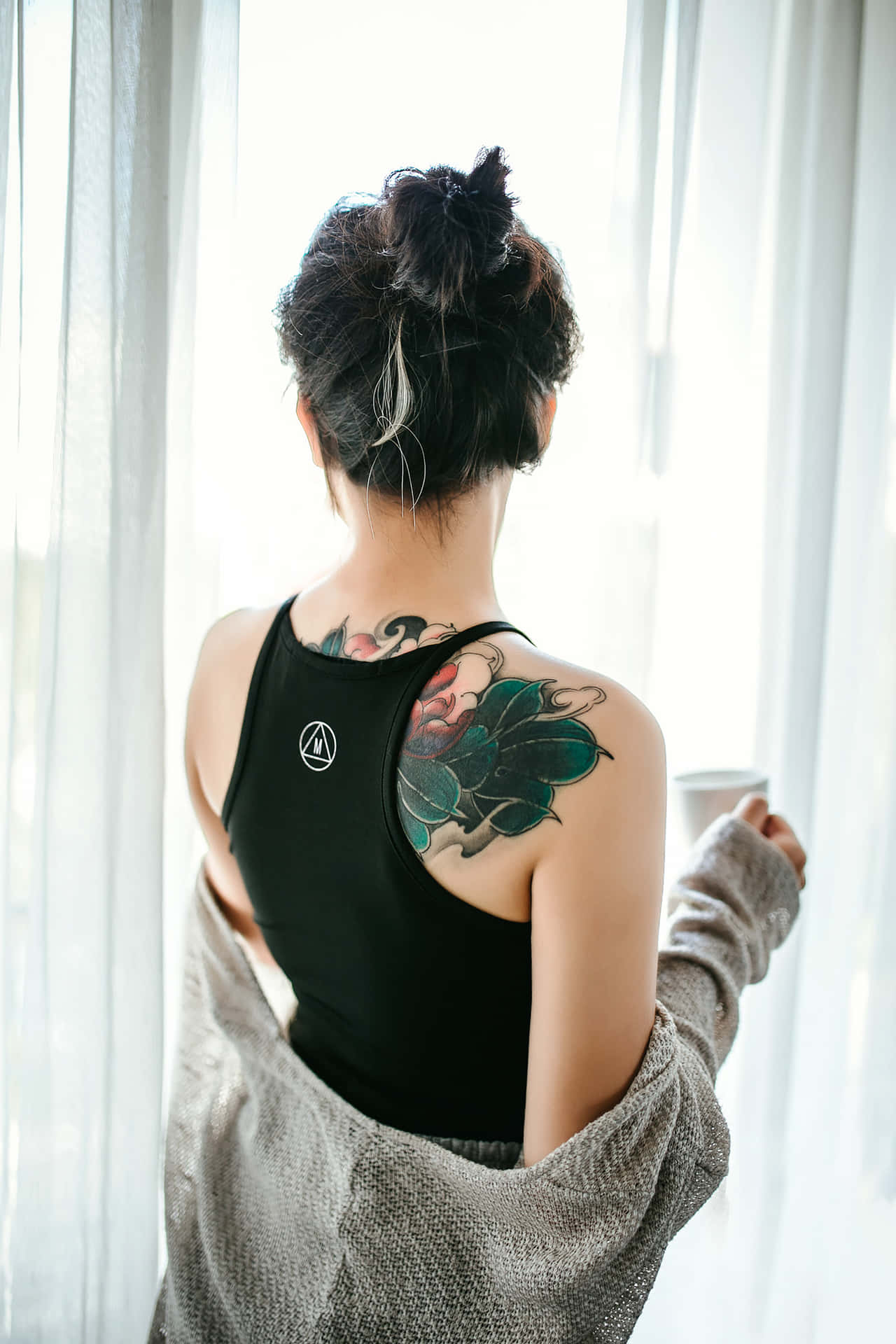 A tattooed girl showing off her detailed art