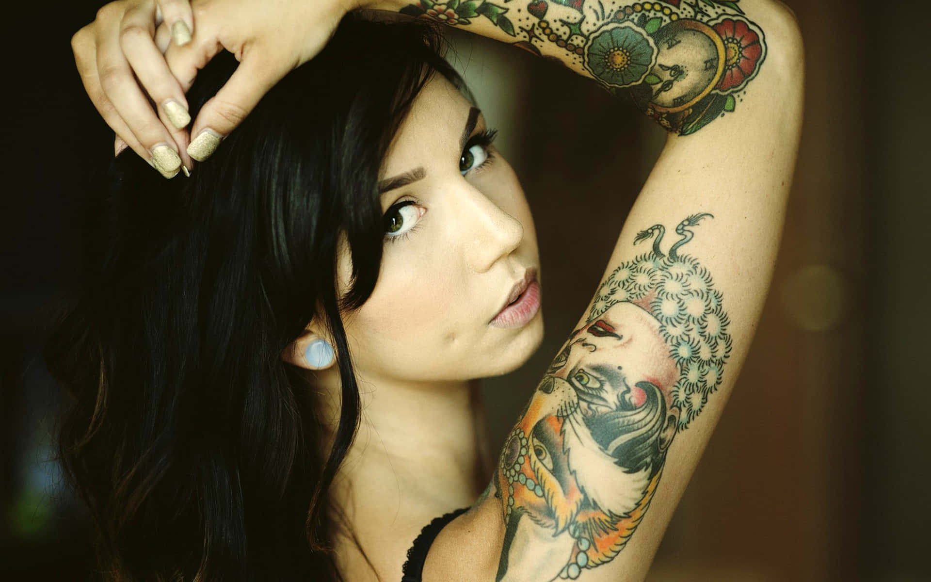 A beautiful pin up style girl wearing a colorful tattoo.