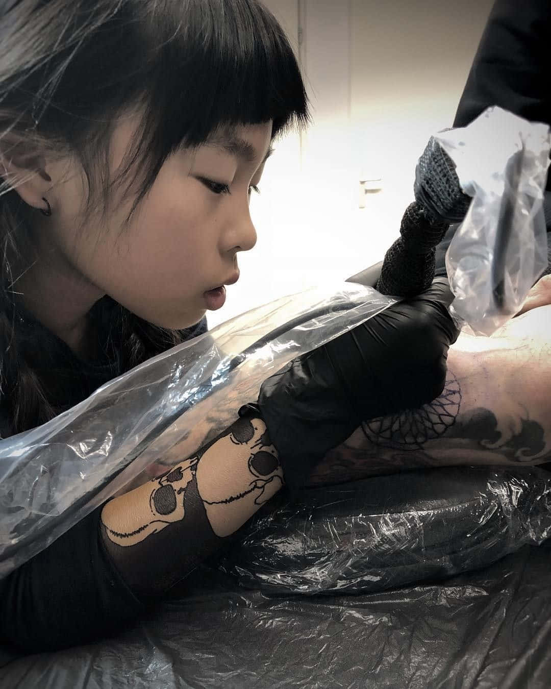 A Girl Getting Tattooed On Her Arm