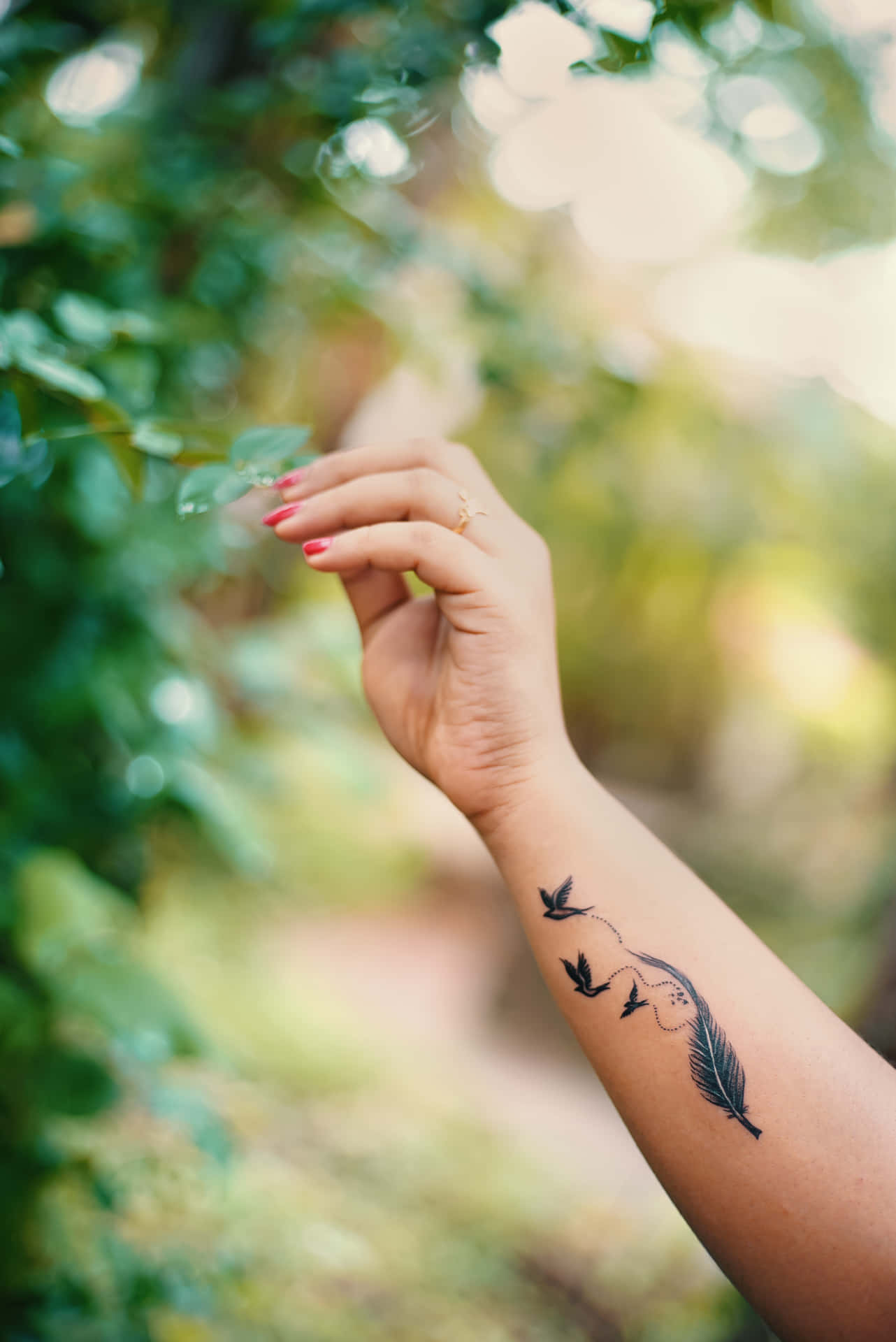 A Woman's Hand With A Bird Tattoo