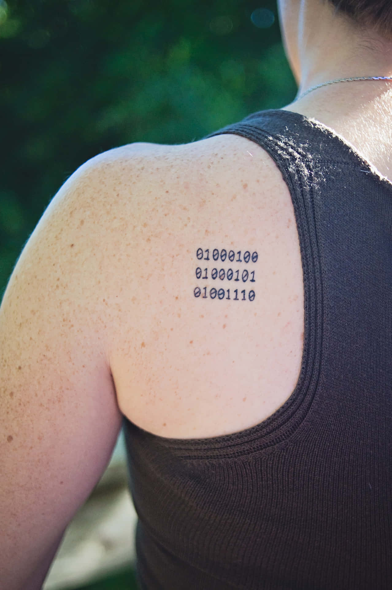A Woman With A Tattoo Of A Number On Her Back