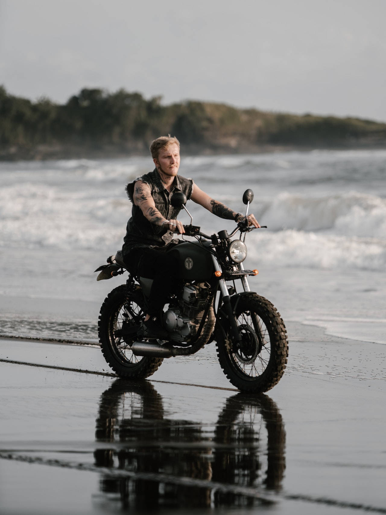 Tattooed Bike Rider Driving Through The Beach Wallpaper