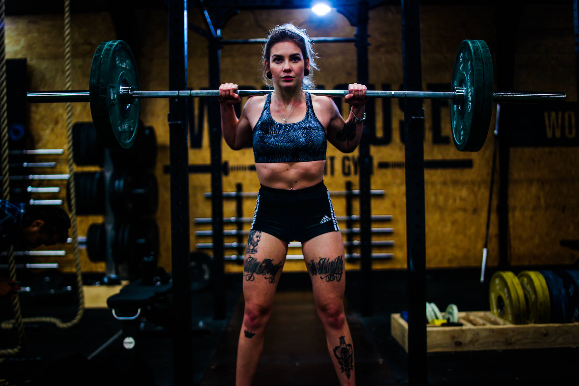 Tattooed Weightlifter At The Gym Wallpaper