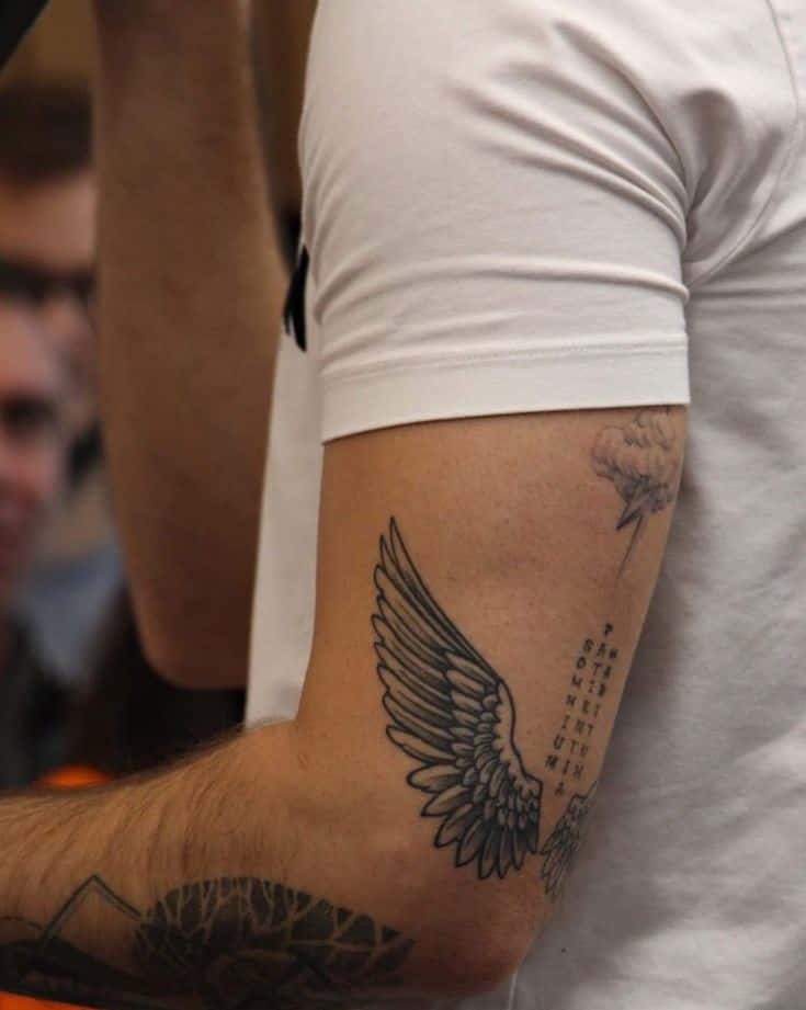 Tattoos Wing On Elbow In Black Ink Pictures
