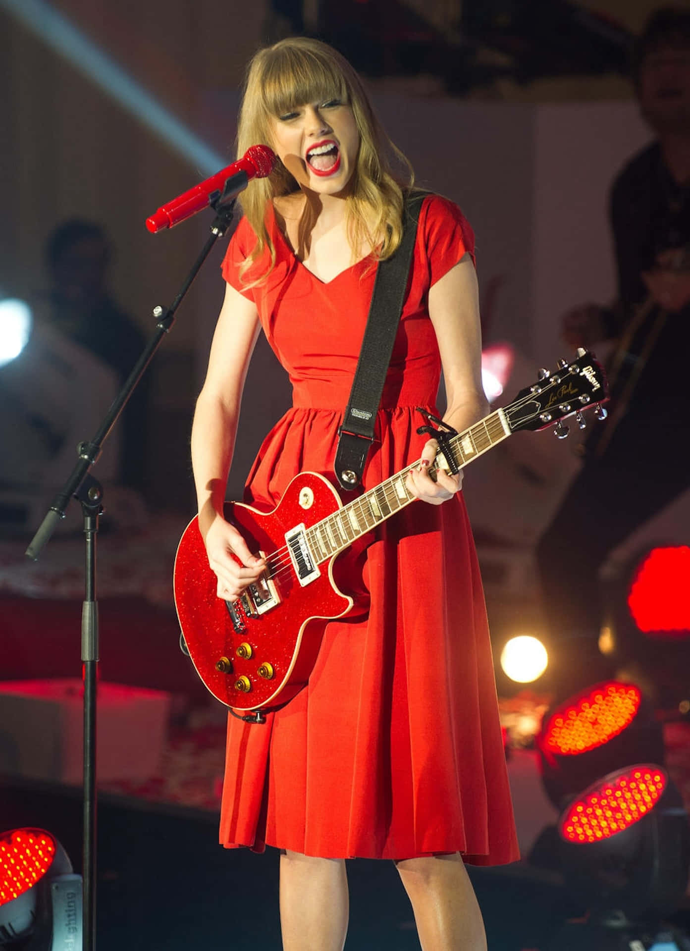 Taylor Swift Red Dress Guitar Performance Wallpaper