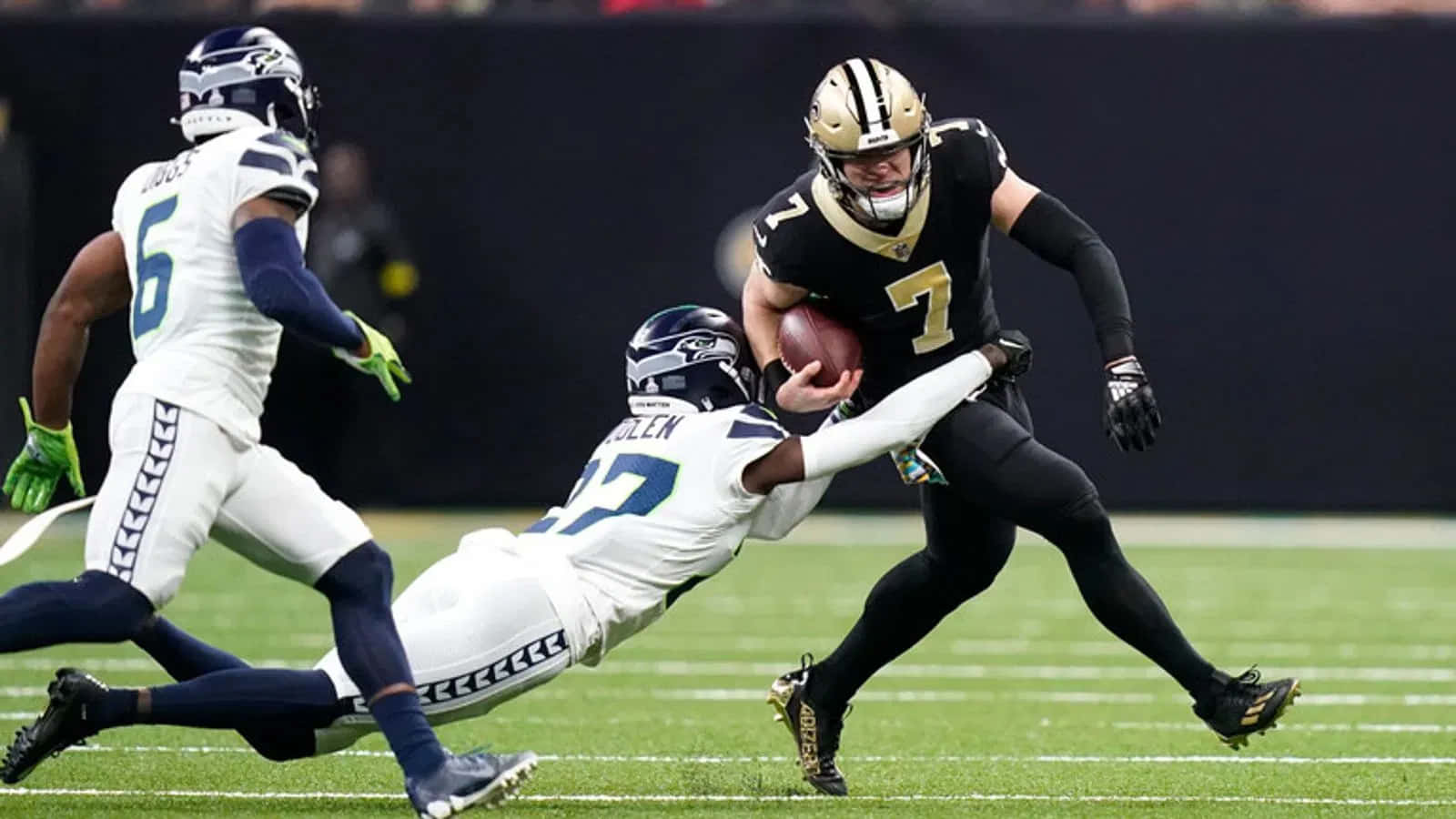 Taysom Hill Evading Tackle During Game Wallpaper