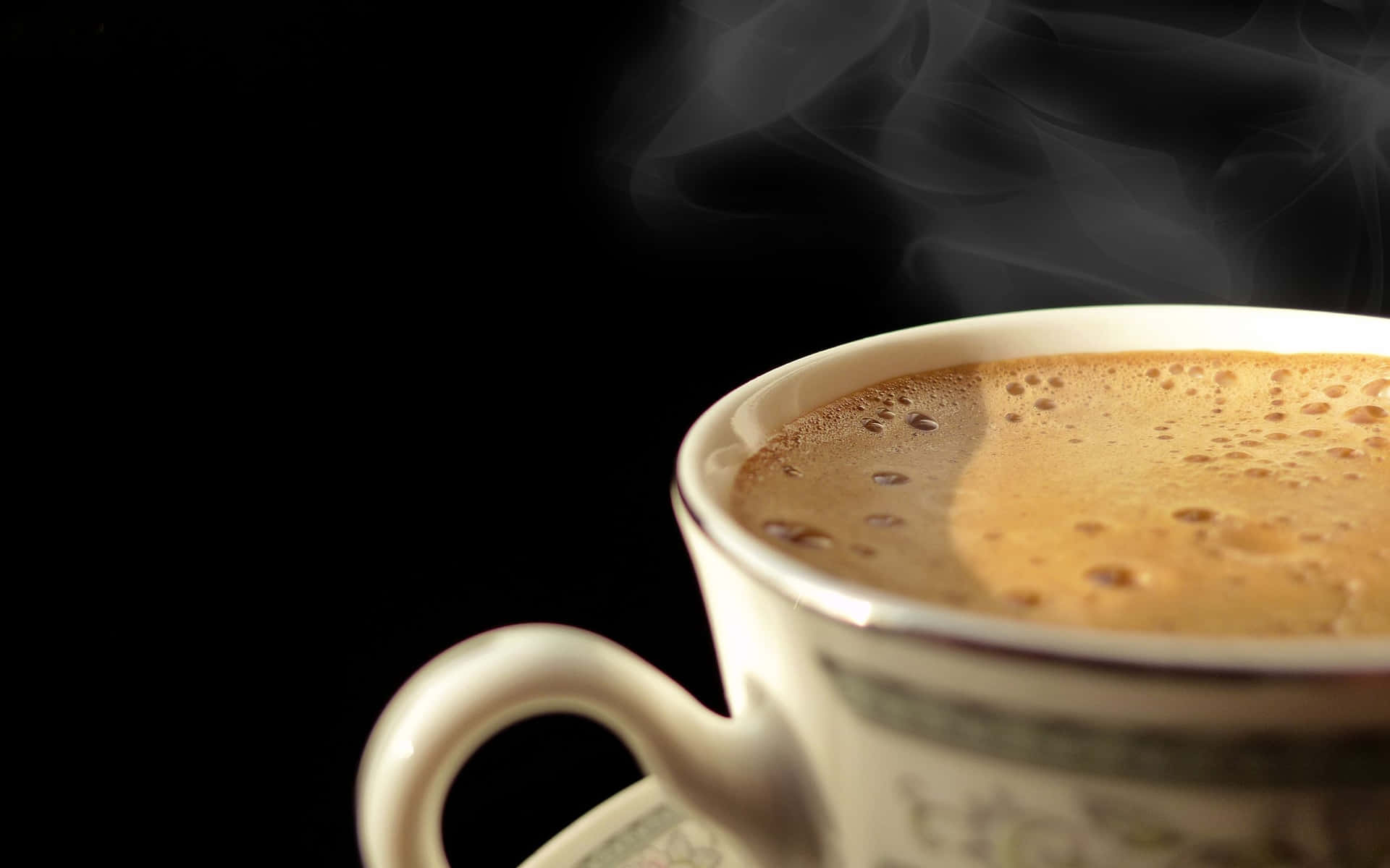 A Cup Of Coffee With Smoke Coming Out Of It