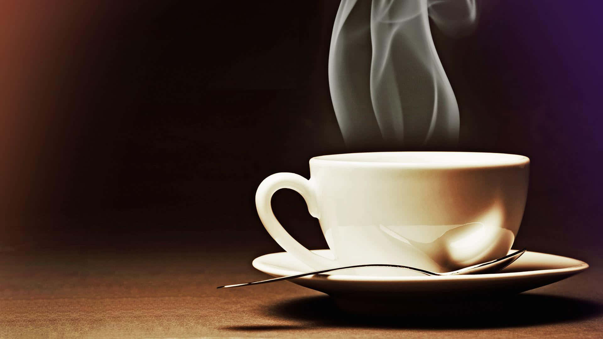 A Cup Of Coffee With Smoke Coming Out Of It