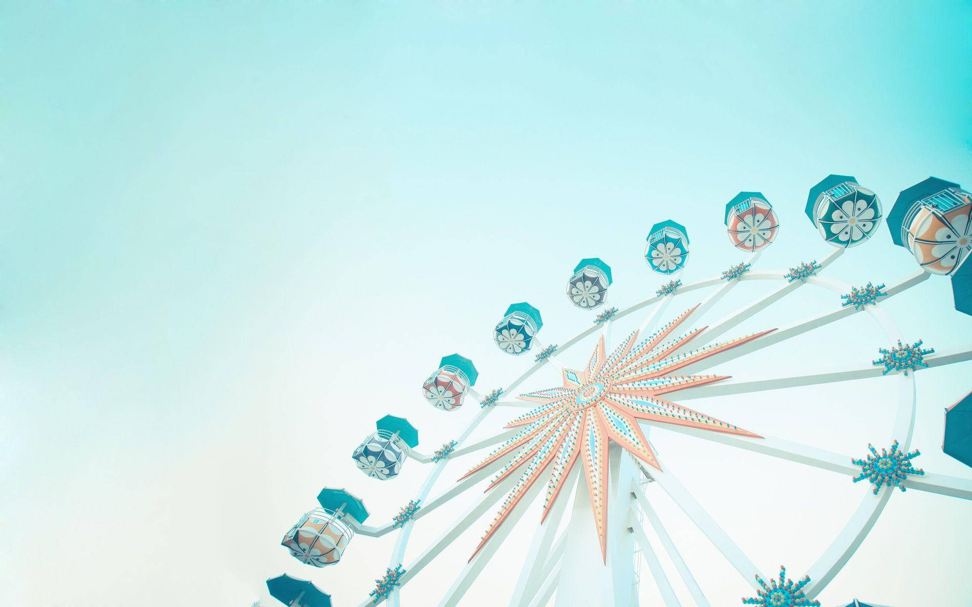 Teal Ferris Wheel Against Bright Sky Wallpaper